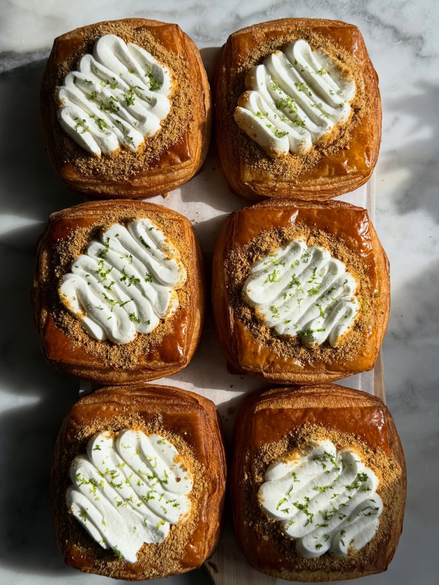 The Key Lime Pie Danish has been piquing your interest at the bakery counter! 🍋&zwj;🟩🌺

Made with flaky croissant dough, a bright key lime custard filling, and topped with a cloud of whipped cream, fresh lime zest, and graham crumbles. A delightfu