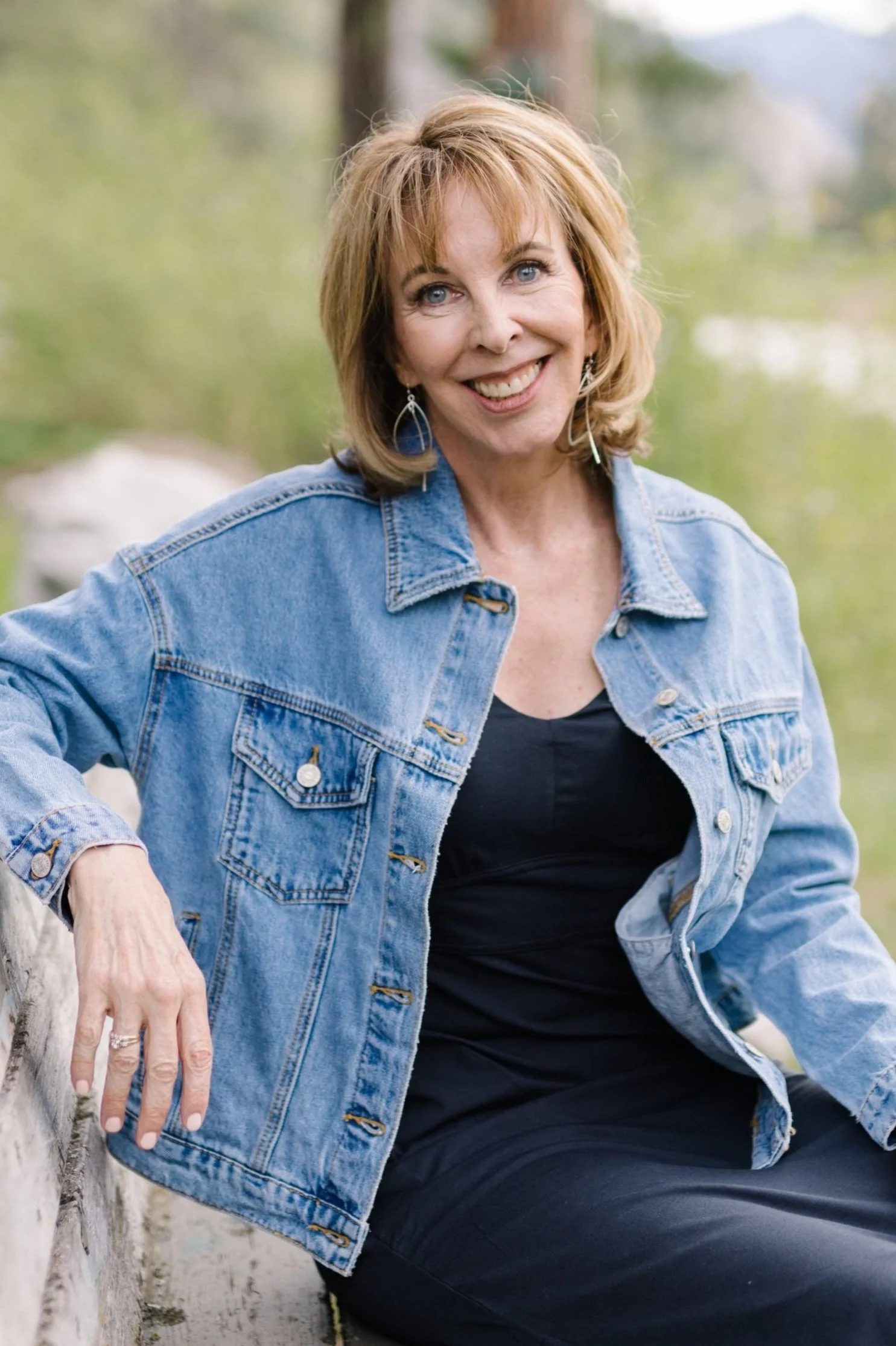 Joan Hoedel, hypnotherapist and coach in Missoula, Montana, sitting outdoors.