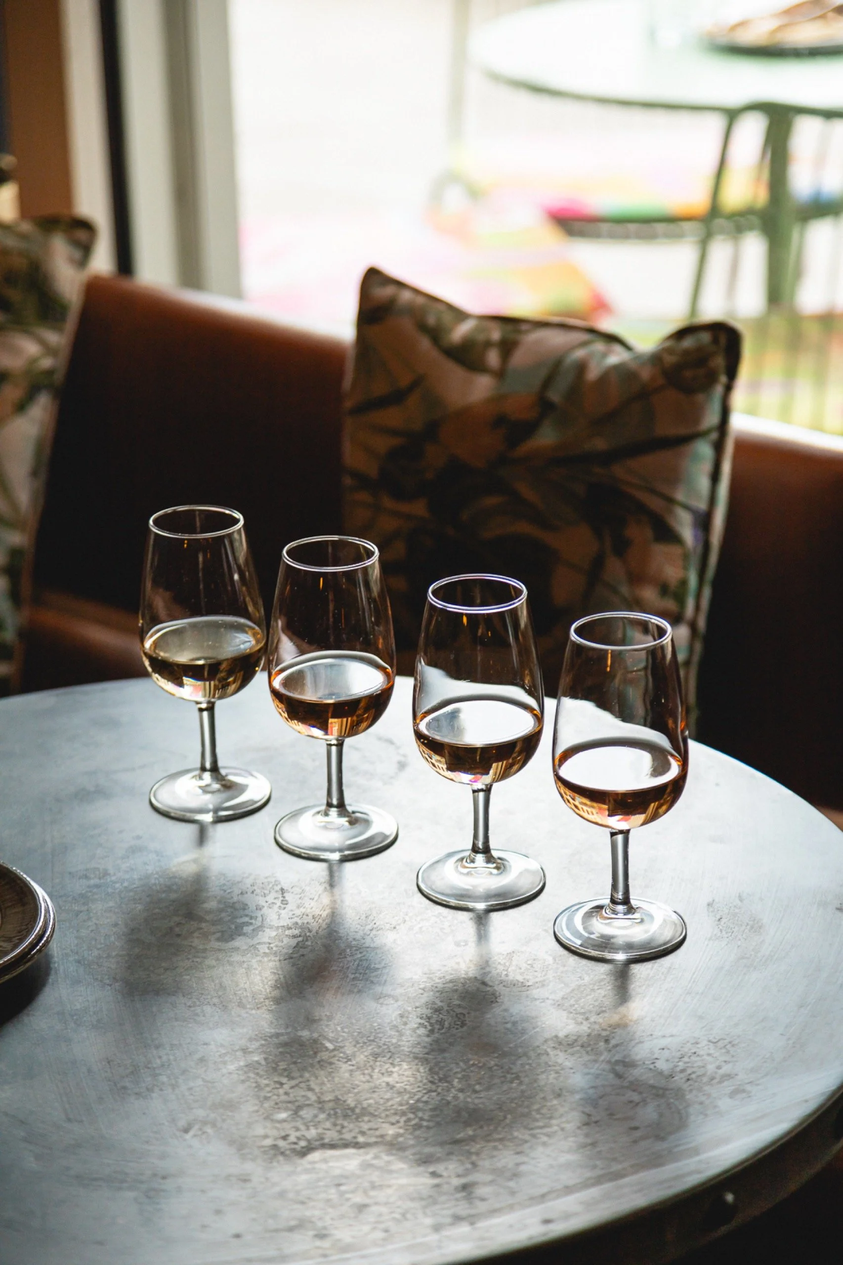 Four tasting glasses lined up on a table at Humble Grape.