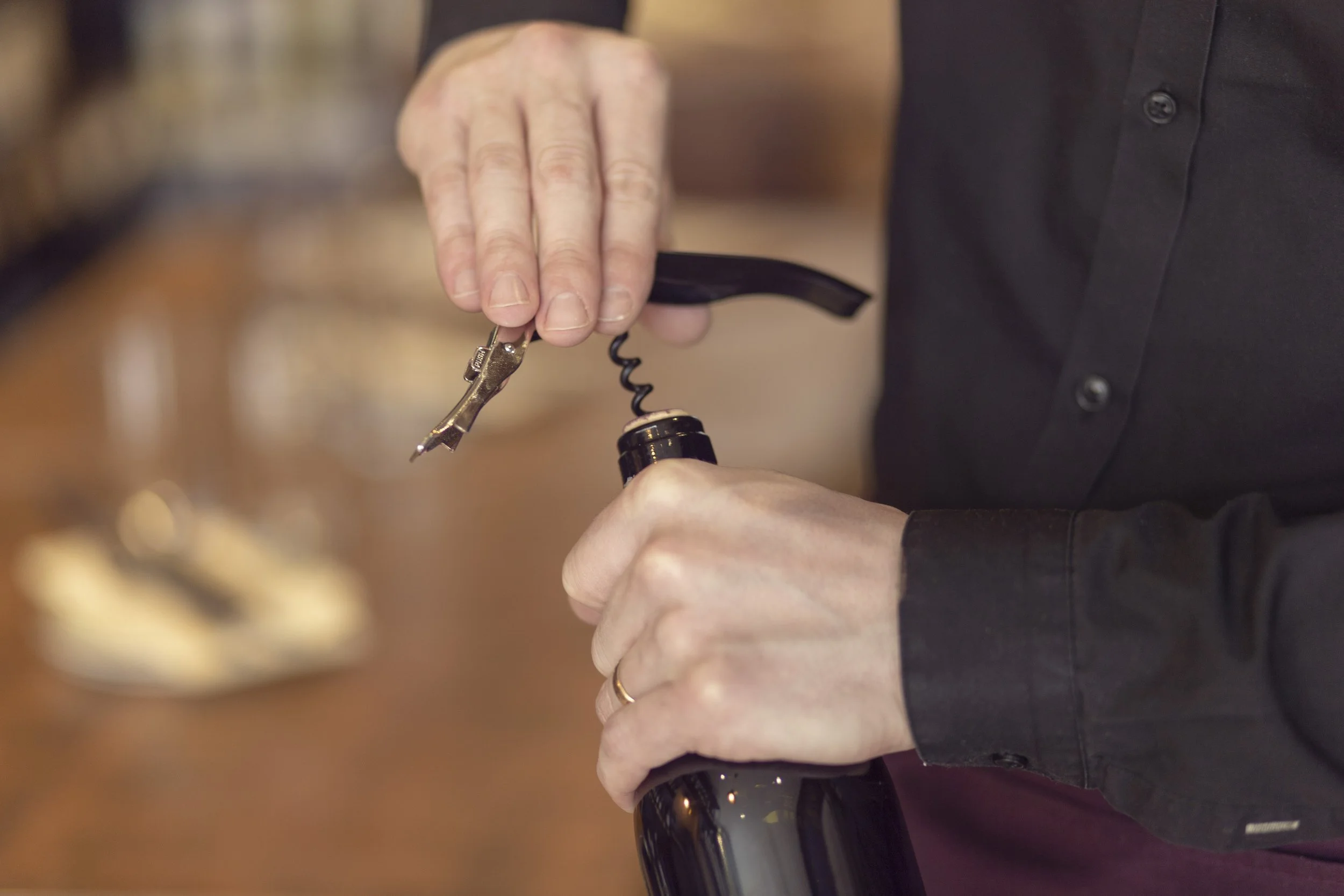 Sommelier opening a bottle of wine