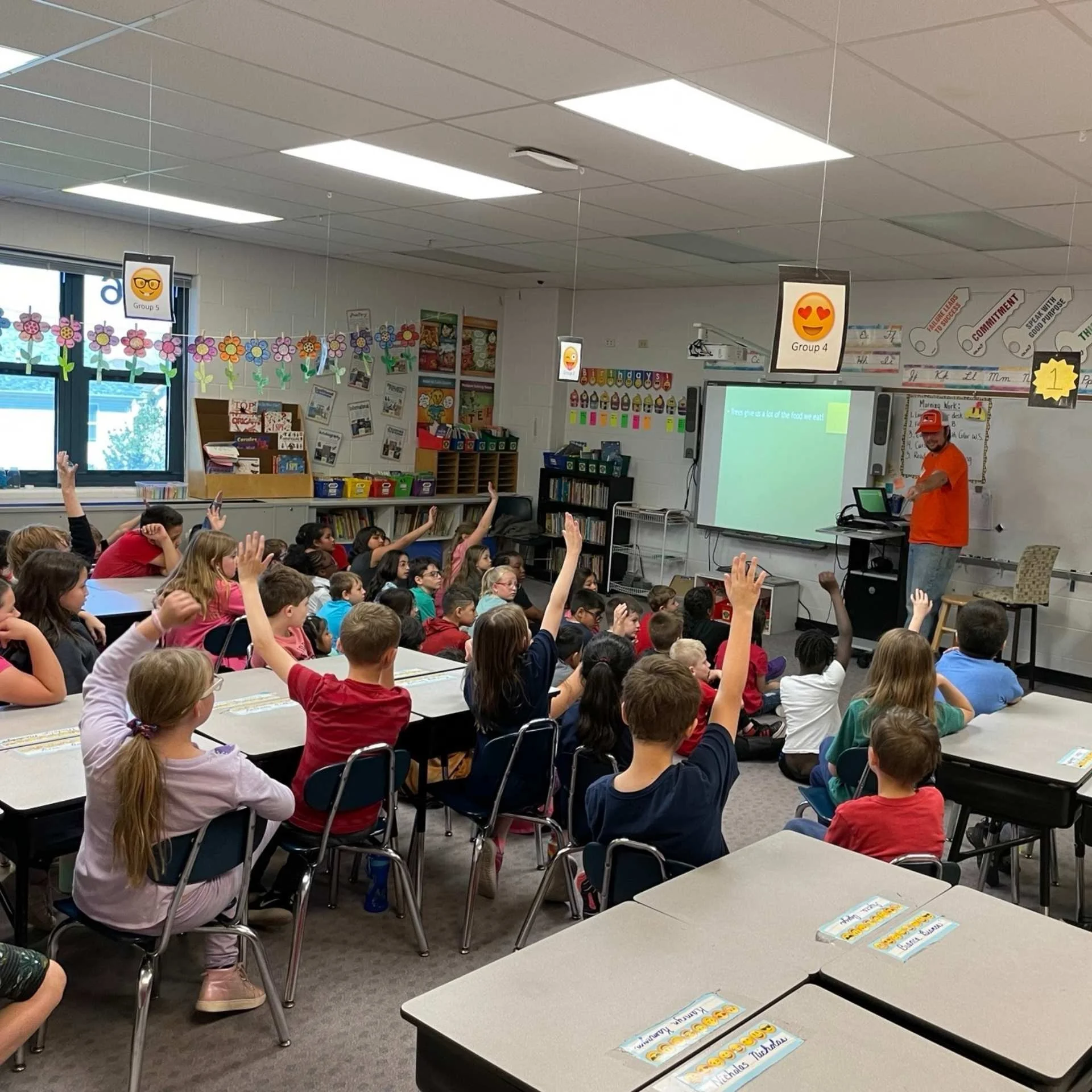 Students participating in Arbor Day activities for kids by learning how to plant and care for trees