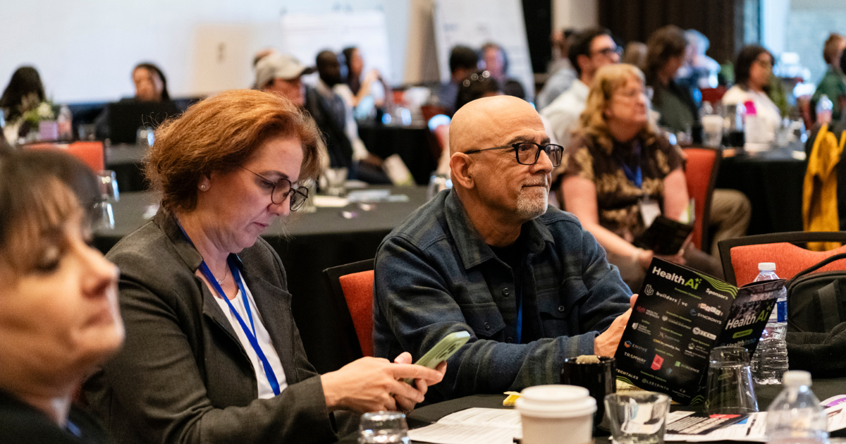 Attendees taking notes at HealthAI 2025