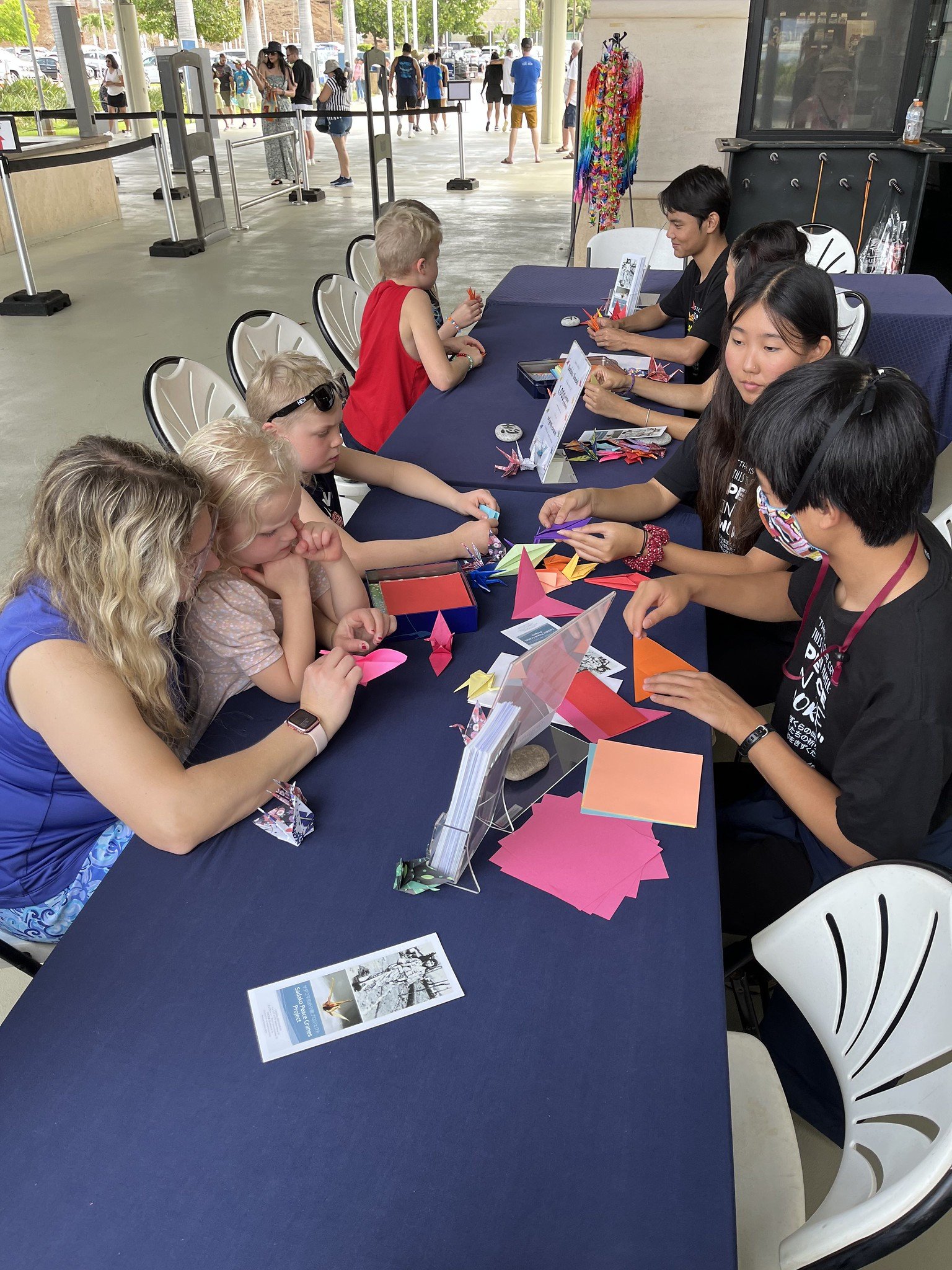  Ohana Arts’ “Peace On Your Wings” cast members teach visitors how to fold cranes 