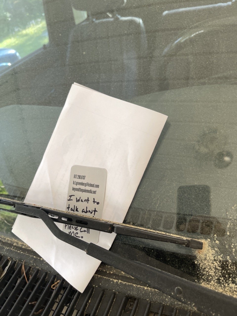 Ben Greenberg's business card and a page from a 1965 witness affidavit left on the windshield of former Ruston, Louisiana police officer Edward Alton Nugent's pickup truck, at his home in Ruston. A note on the business card reads, "I want to talk ab