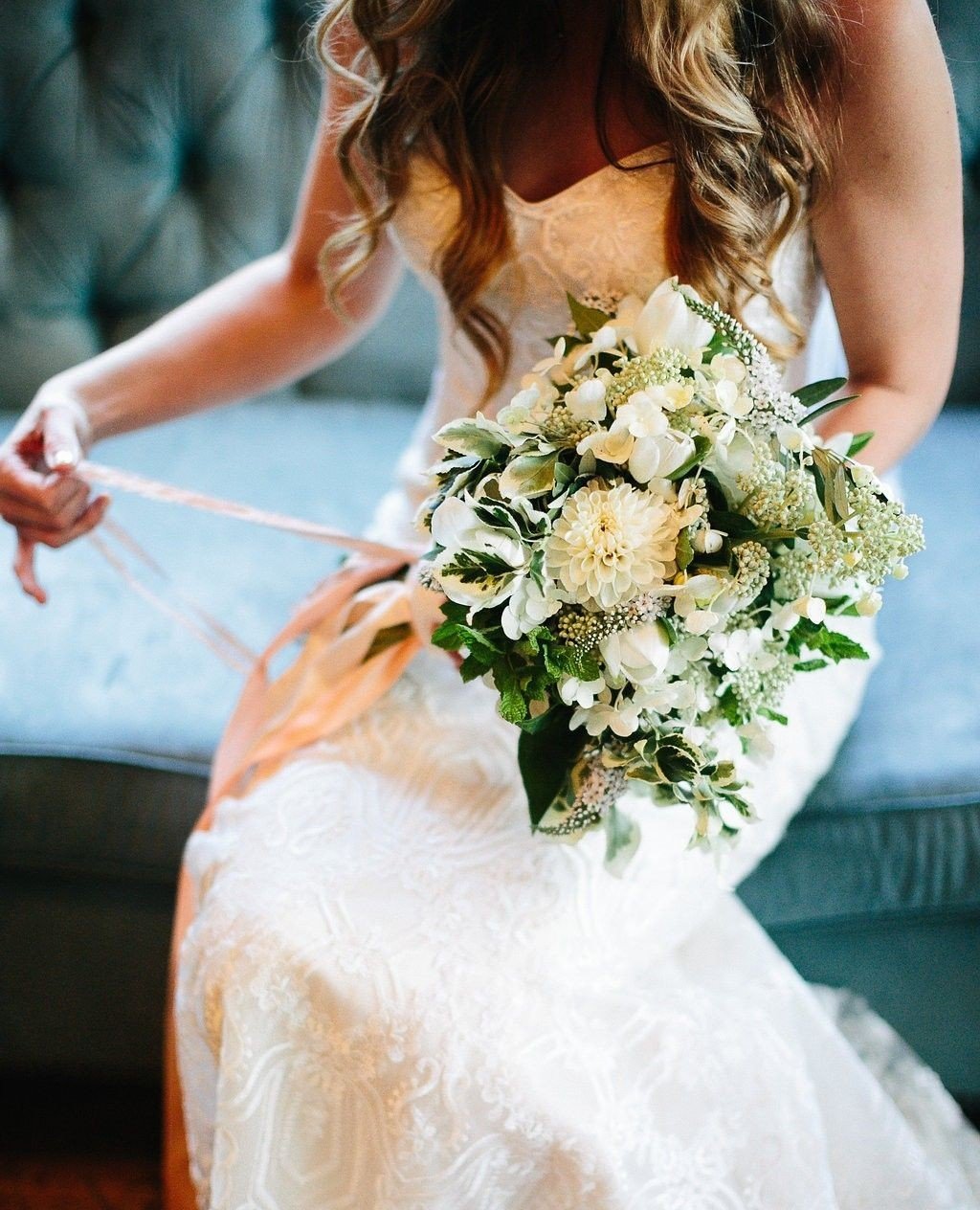 Embracing the beauty of spring with this ethereal bouquet. 🌷Notice how it perfectly complements the textures of the Bride's lace dress and velvet couch? A great florist who understands you, your personality and your entire wedding day vision will wo
