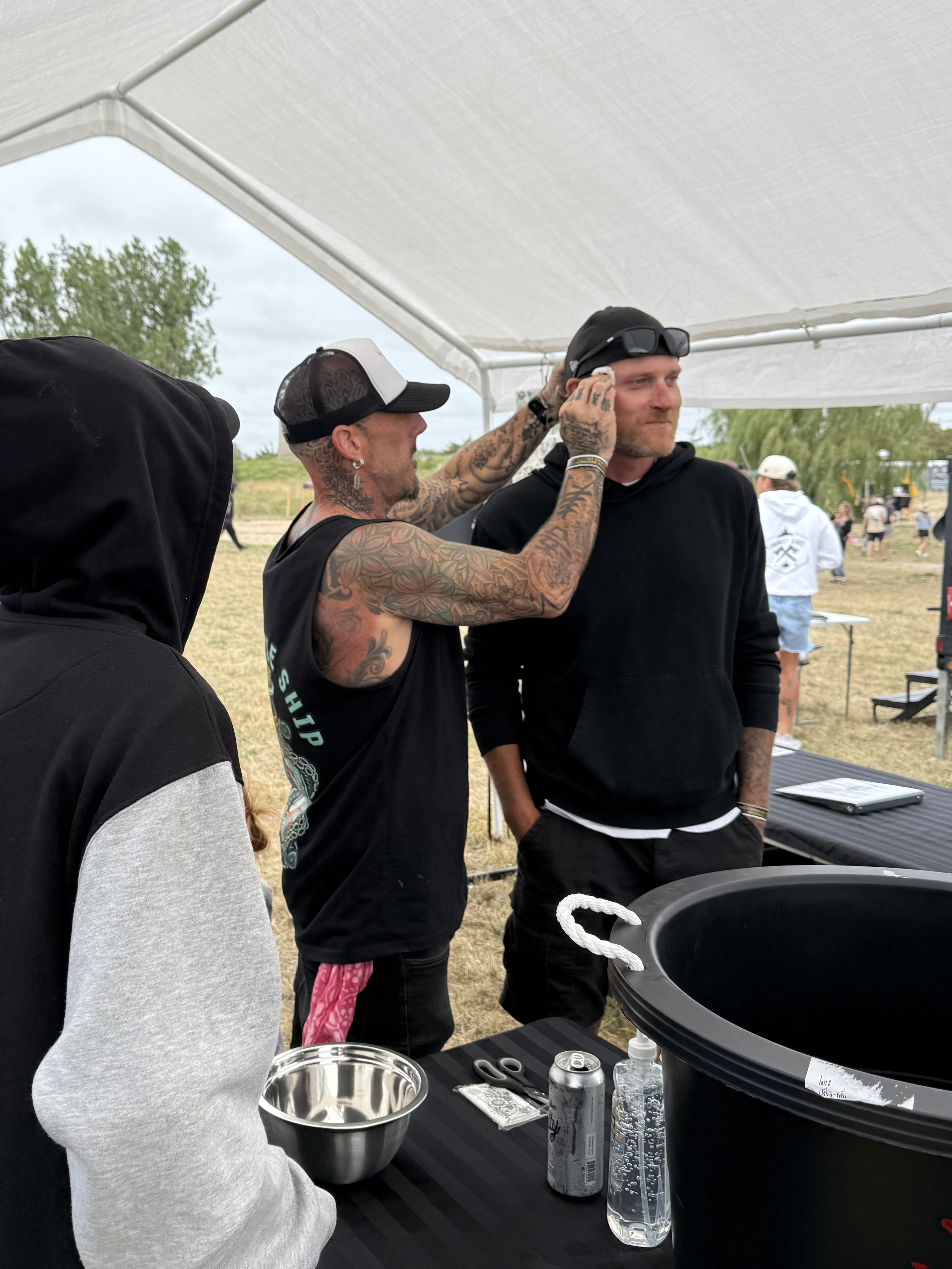 Owner Dan getting a temporary tattoo from Owner and Artist Daniel at the Lakeside Booth at B2TF!