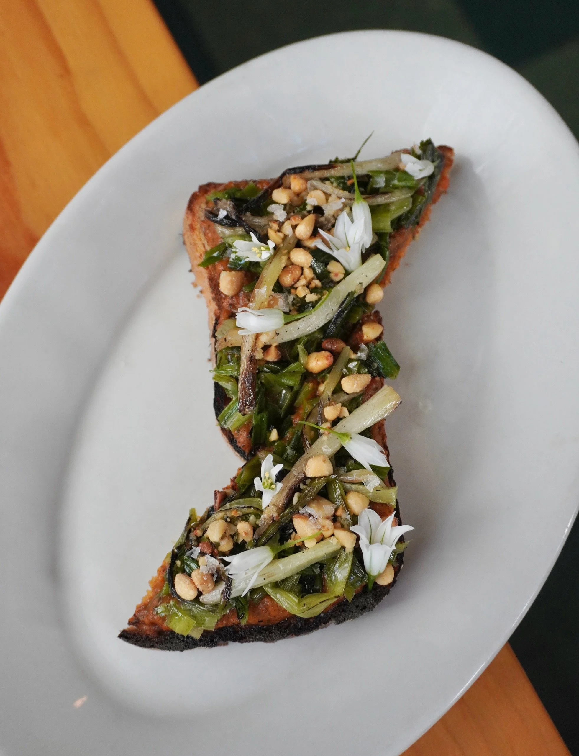 Spring flavors are going off over here and this new Wild Onion Buterbrod is no exception! 🧅 

With smoky ajvar spread on grilled @toothbutterpdx (duh) rye toast. Topped with pine nuts and lemon juice, it&rsquo;s a perfectly balanced spring bite.
