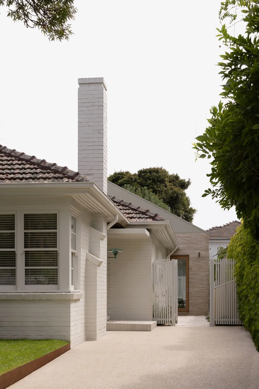 Side perspective of Silver House by By Mysa showing the transition from heritage brick to a contemporary modern extension.