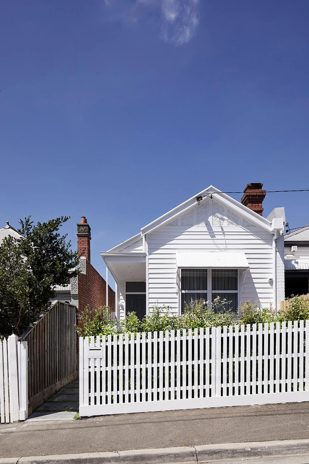 Restored Victorian facade of Richmond Hill House with neutral tones and contemporary landscaping