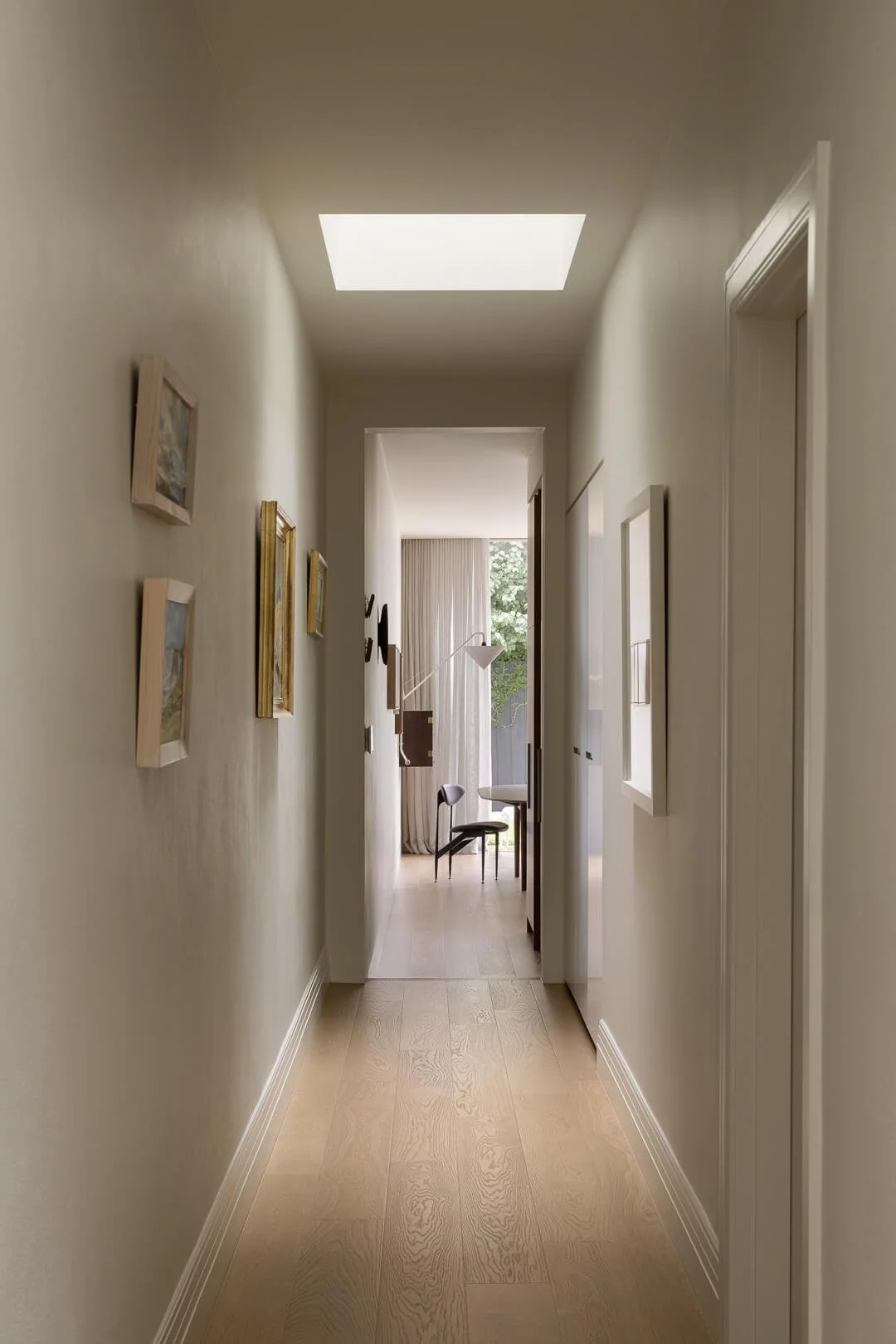 Internal hallway of Silver House featuring a large skylight and a transition from heritage architecture to a modern open-plan living zone.