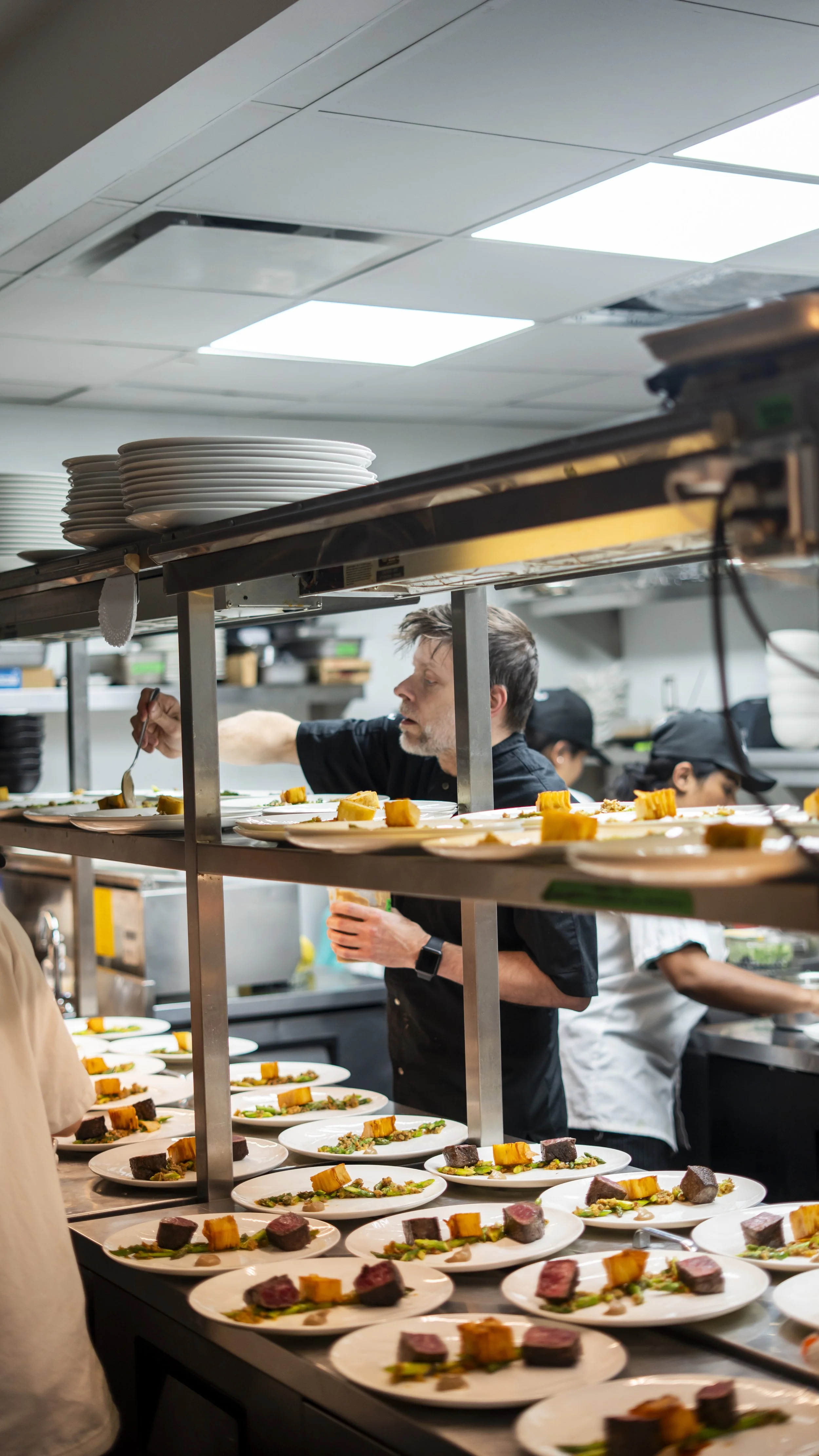 The view of inside a restaurant kitchen from the outside.