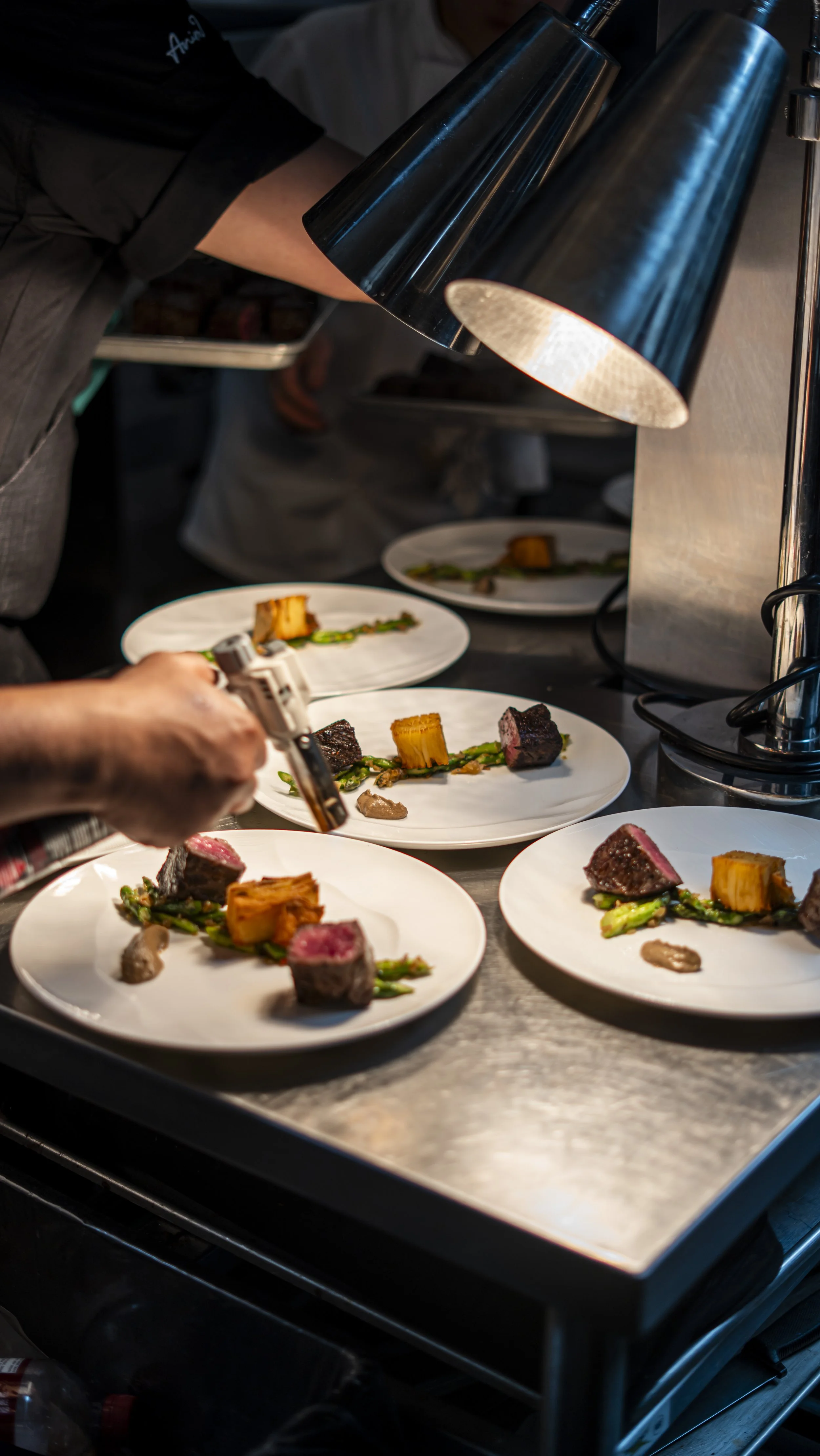 Plates being finished in the kitchen to be sent to tables