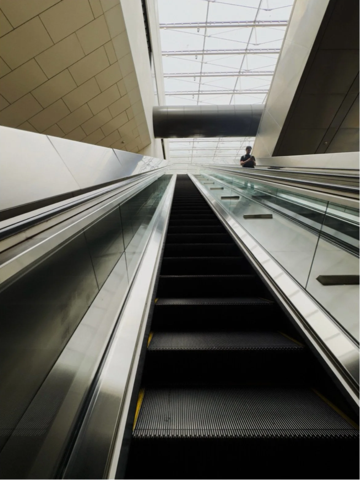 Escalator ride, Bras Basah MRT.