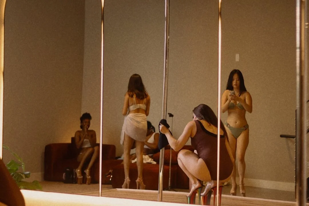 Group of women in platform heels between sets at PoleBait Haus — intimate small group pole training and community in Downtown Los Angeles