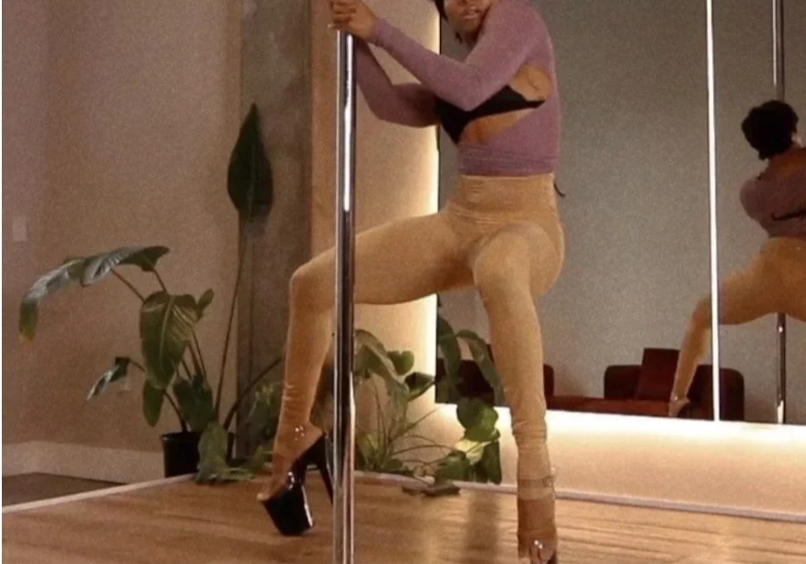 Woman learning fluid pole flow at PoleBait