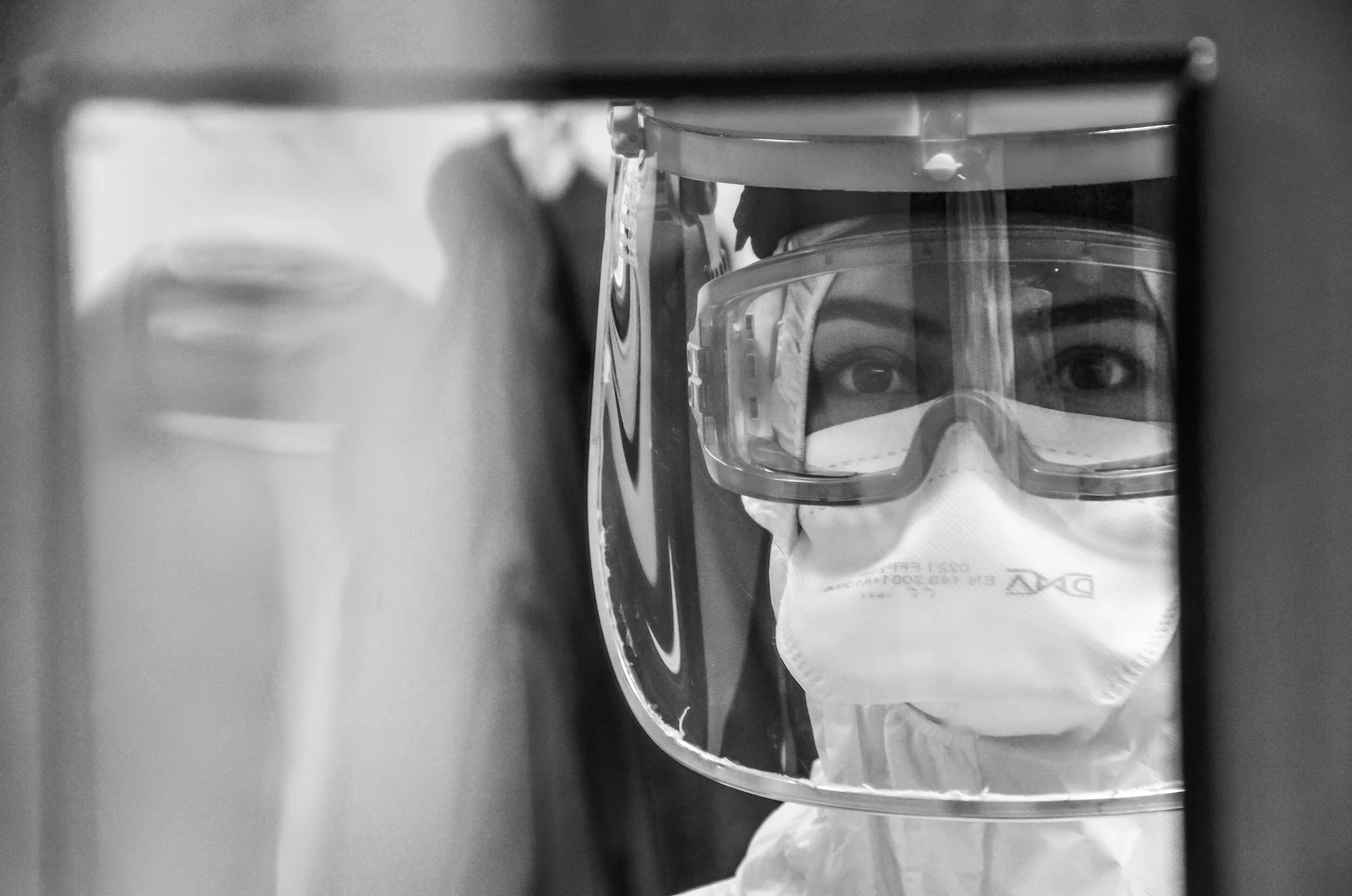 Registered Nurse in mask, goggles, and full isolation gear