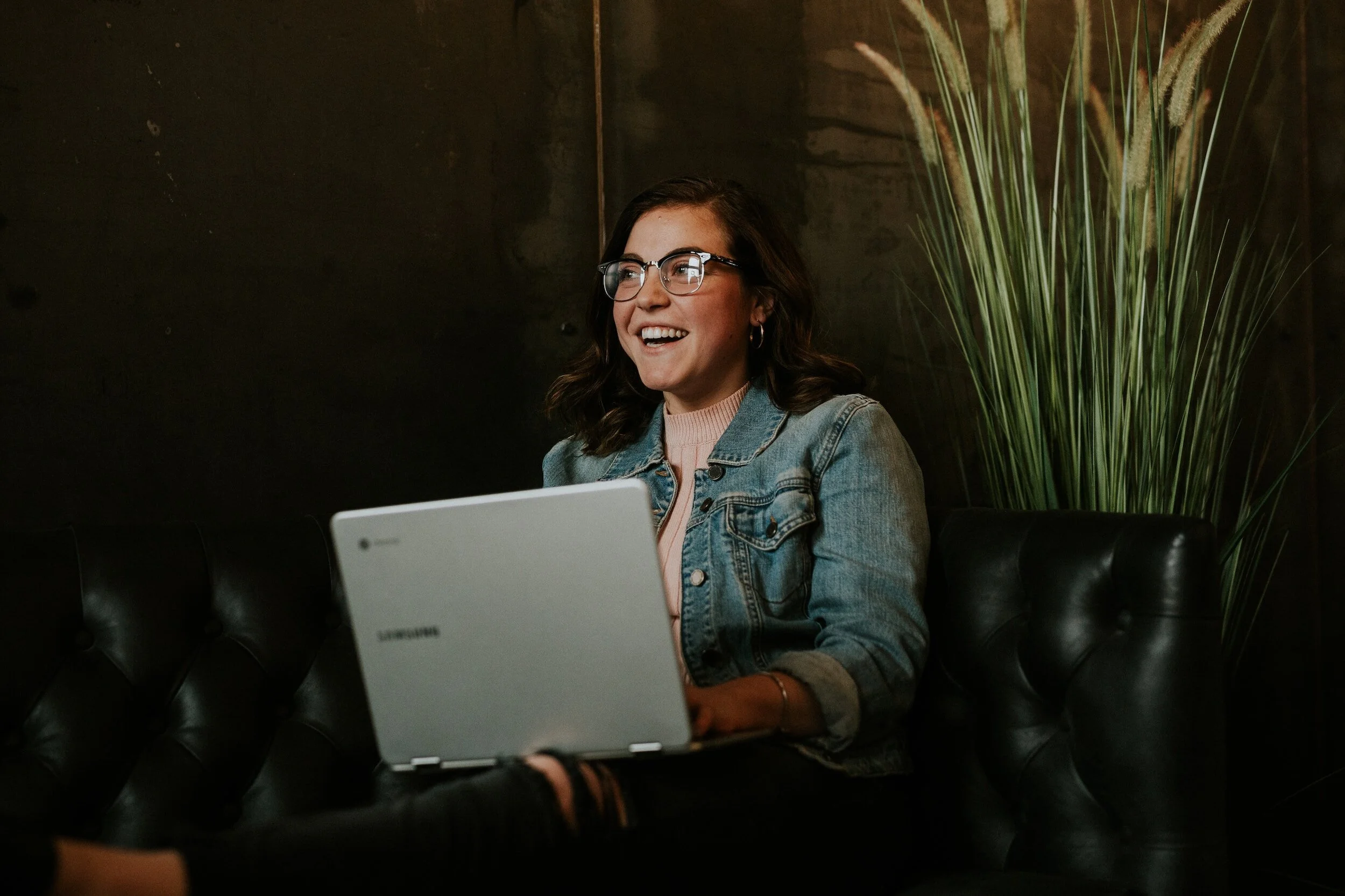 happy, smiling woman looking at website written by a health and wellness copywriter