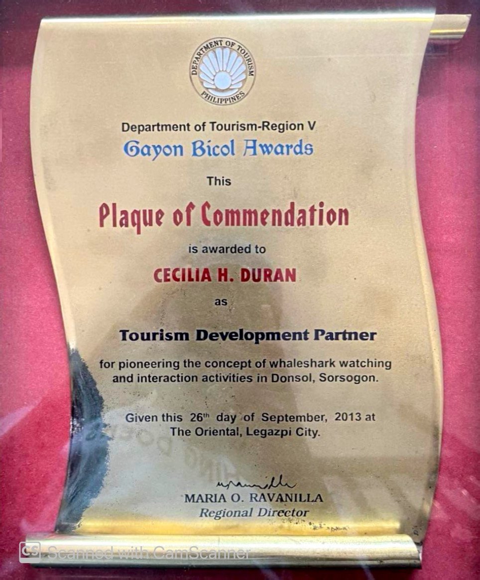A trophy plaque from the Department of Tourism-Region V in the Philippines, awarded to Cecilia H. Duran for pioneering whale shark watching activities in Donsol, Sorsogon, dated September 26th, 2013, signed by Maria O. Ravanilla.