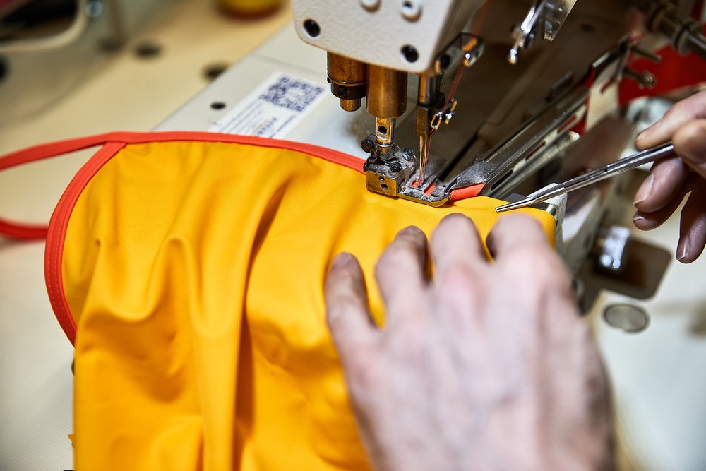 A swimsuit being sewn by machine.