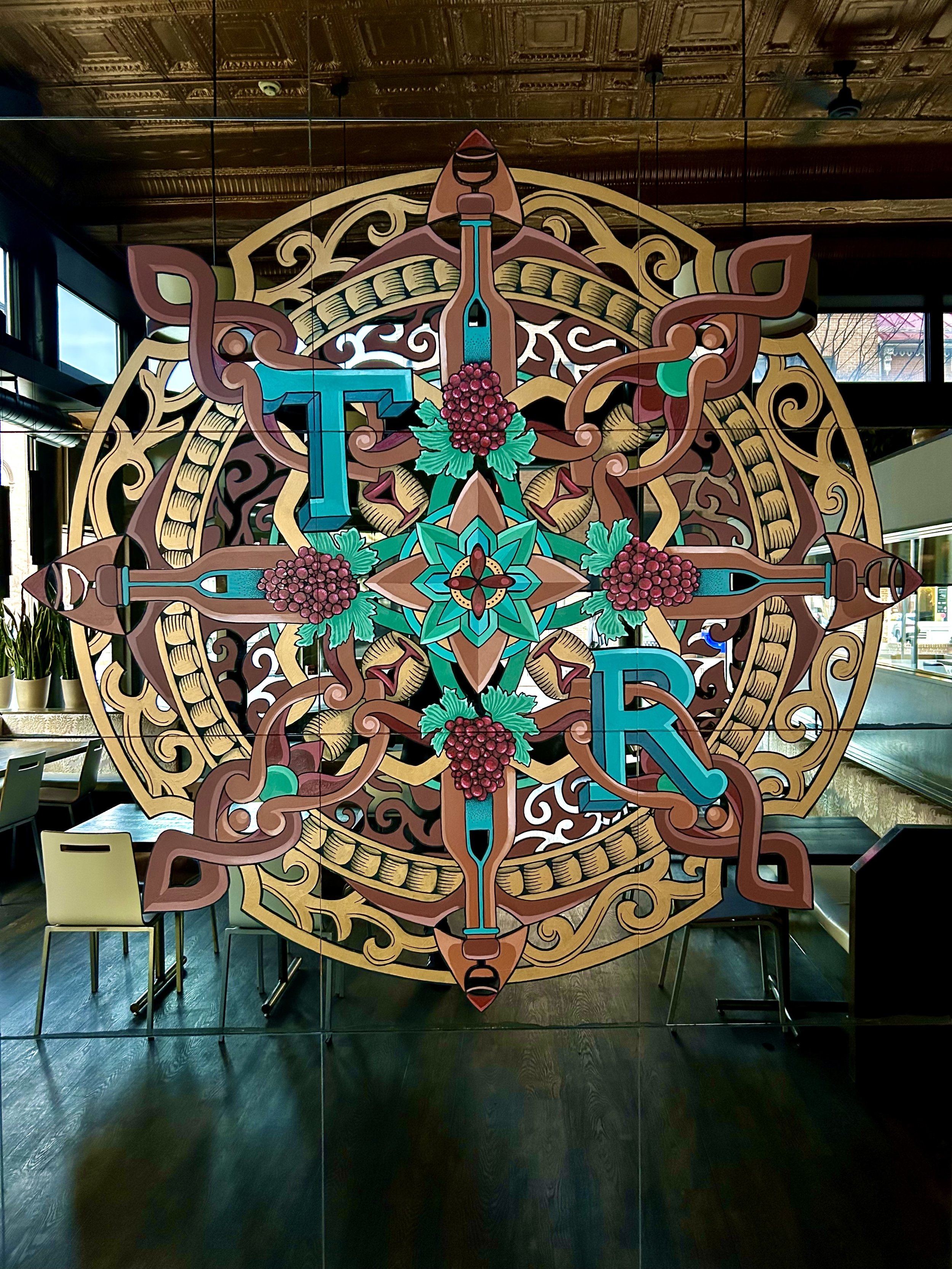 Mirror Mandala- Acrylic painted on a mirror at The Tasting Room in Frederick, MD.   A Decorative piece to tie elements of the restaurant together and provide a fresh focal point while keeping the mirror's effect in the space