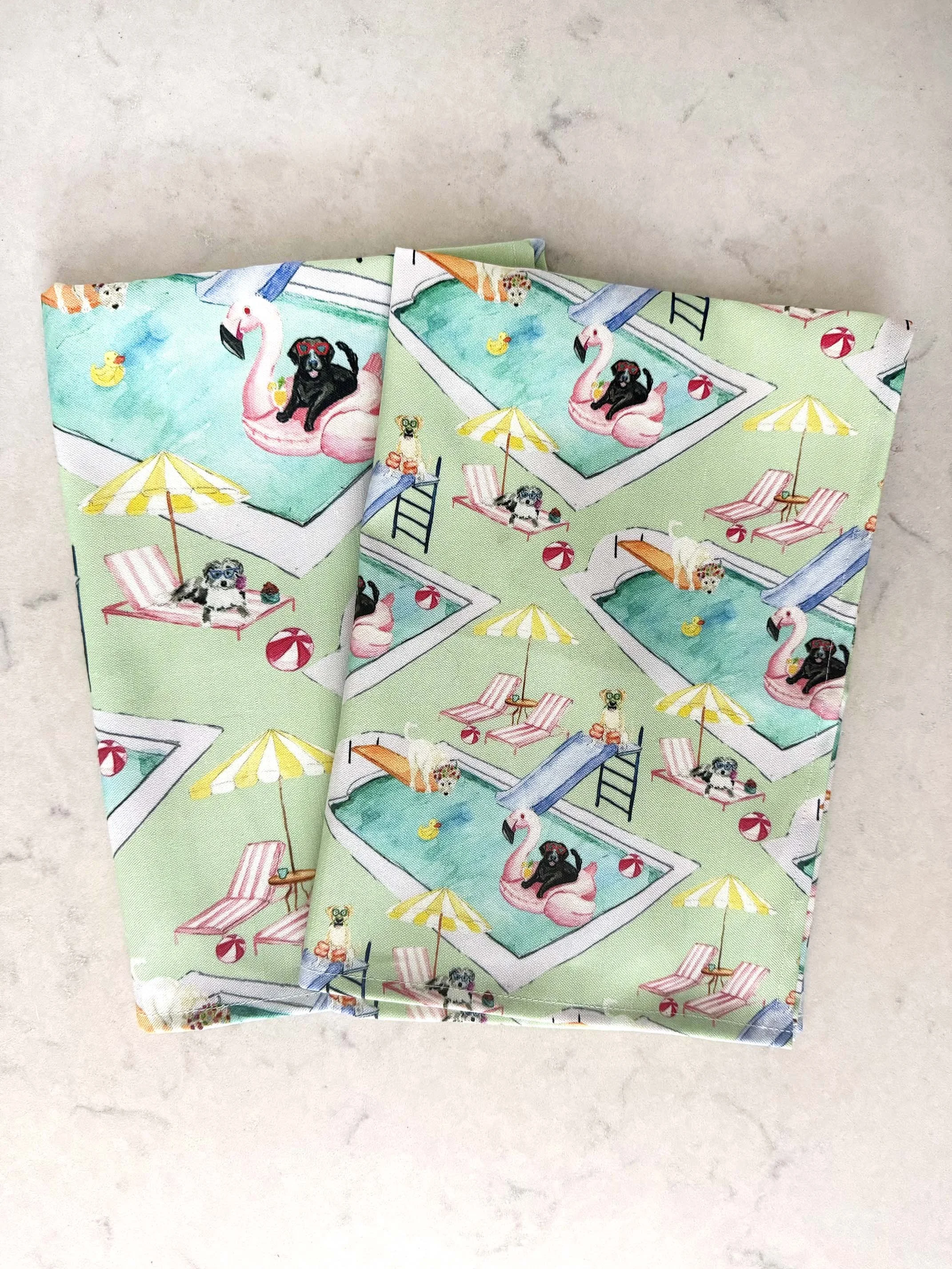 green dishtowels with custom dog print by the pool