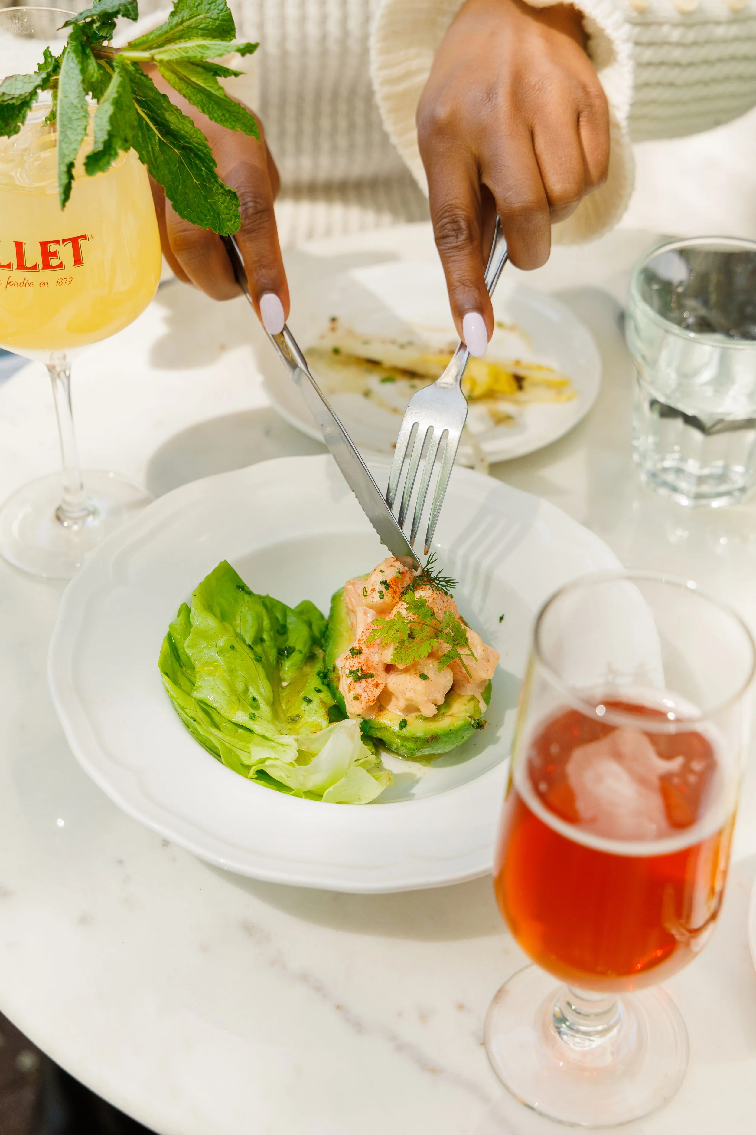 Shrimp and Avocado cocktail being cut by a fork and knife