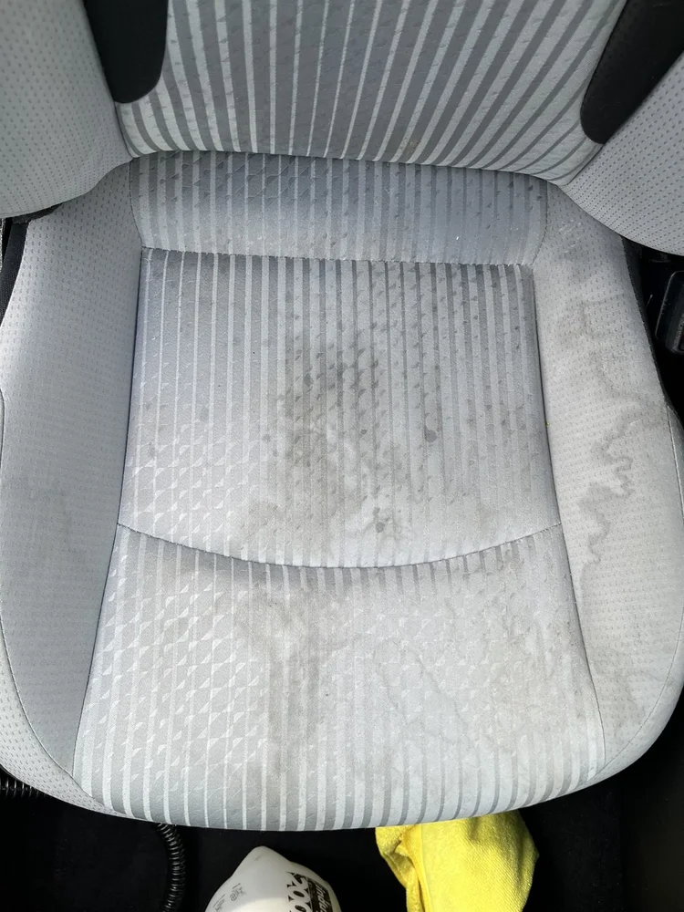 Stained cloth driver seat before shampoo