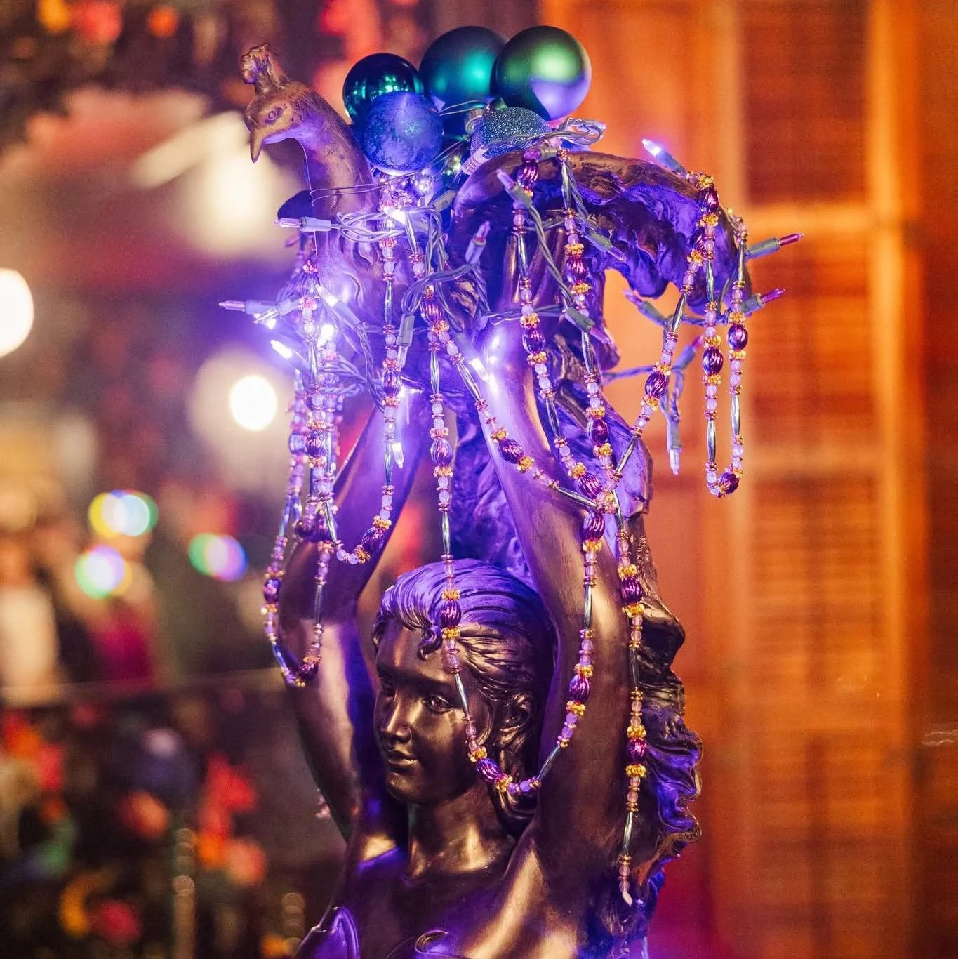 Sculpture of a woman with peacock lights in the Peacock Bar Room. Photo Courtesy of Shannon Beth Photography.
