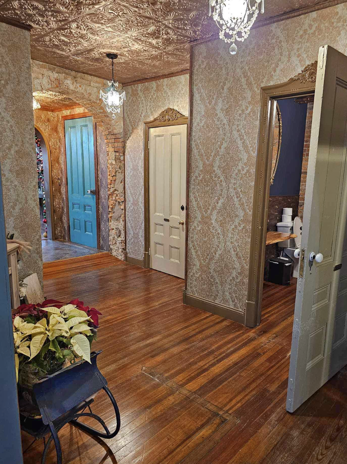 Archways and bathrooms in the hallway at The Relic.