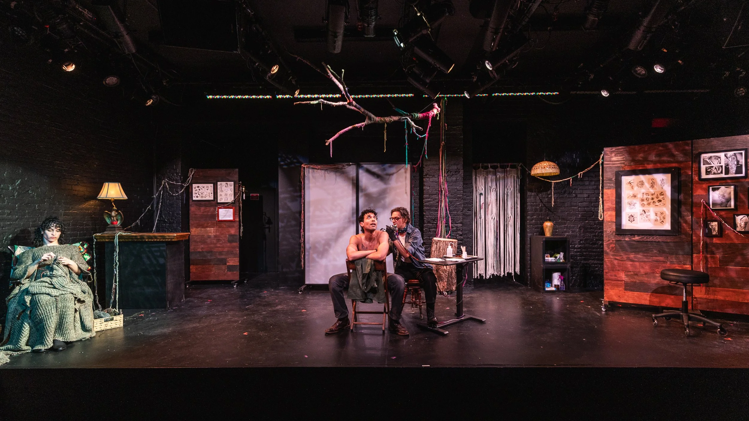 Izzy gives Hector a tattoo. The Knitting One watches. (Photo: Adam Fontana)