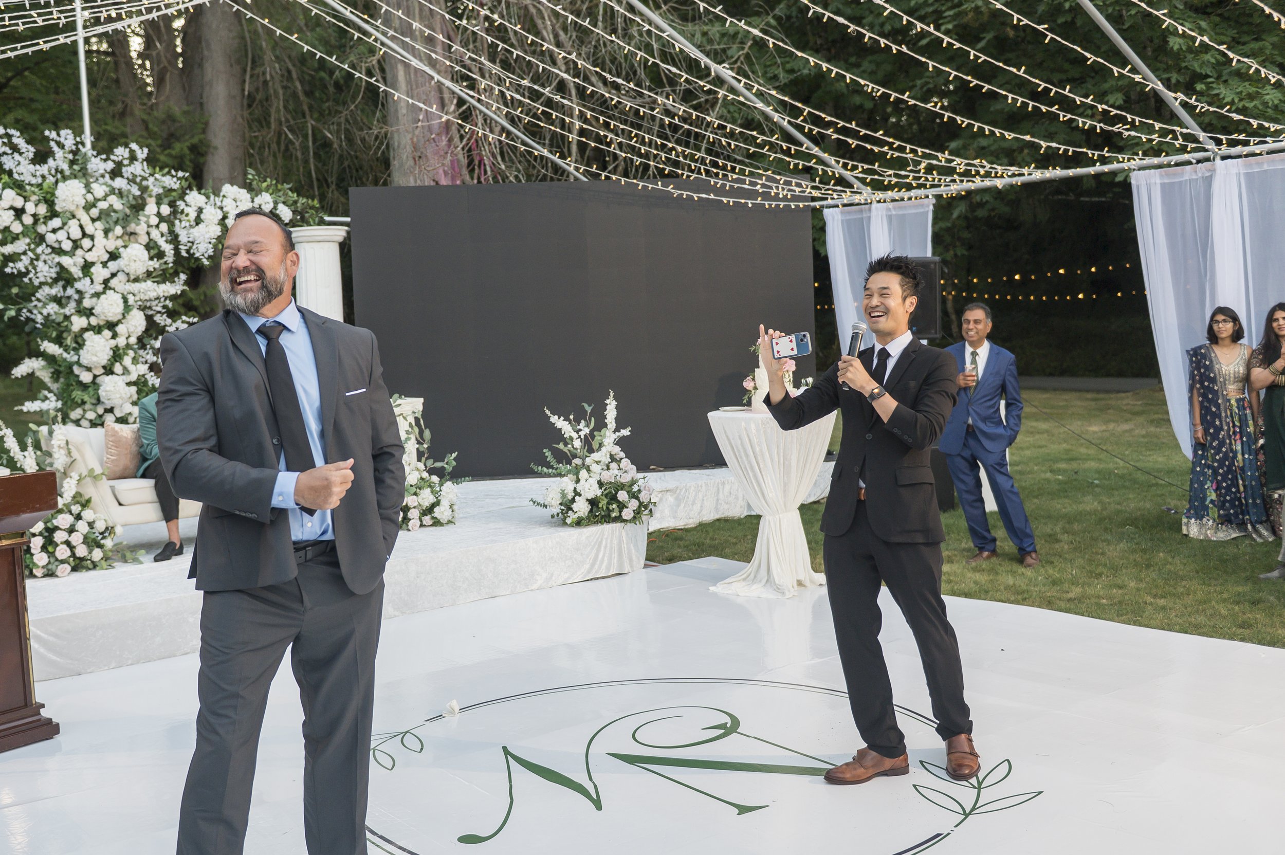 Kel Ng performs stage magic with a wedding guest during the program at Neeraj and Natasha's Indian wedding in Vancouver