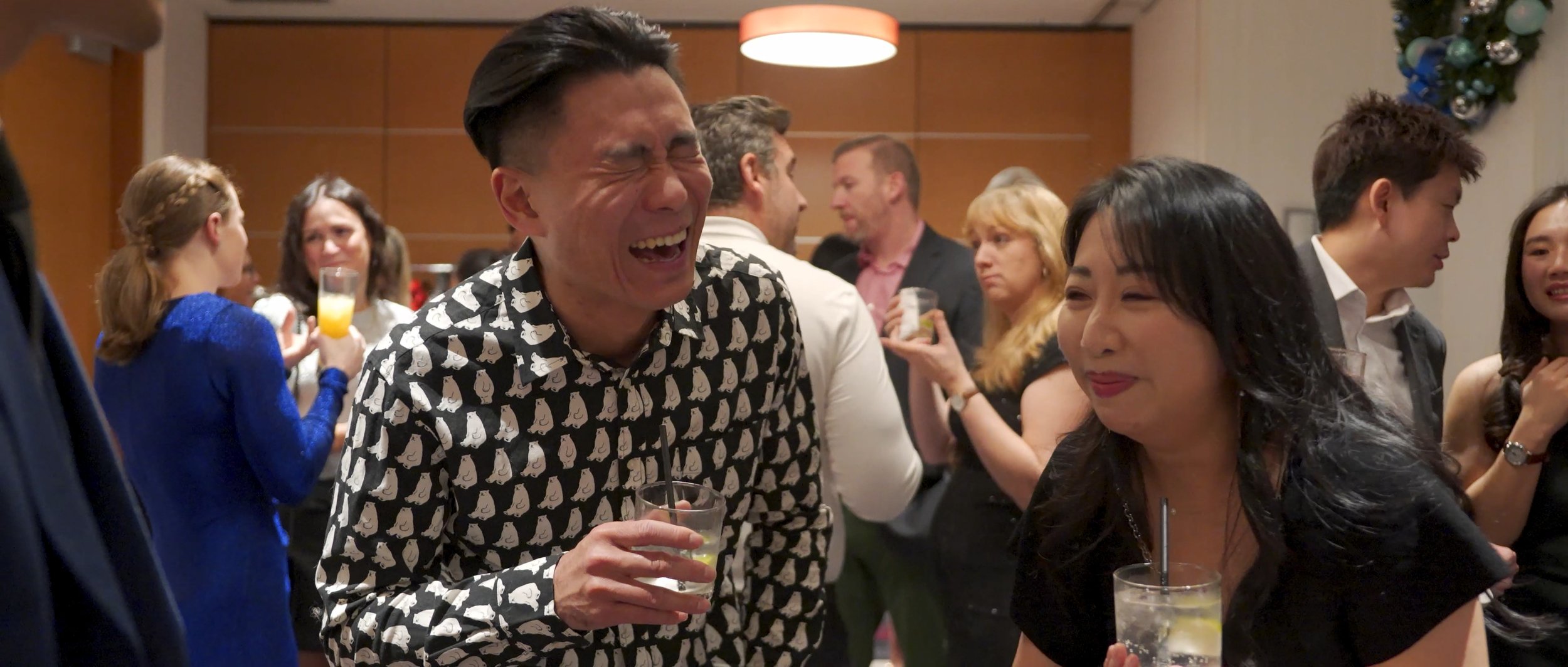 Guest in patterned shirt reacting to close-up magic at Endeavour Silver Christmas party, Hyatt Regency Vancouver
