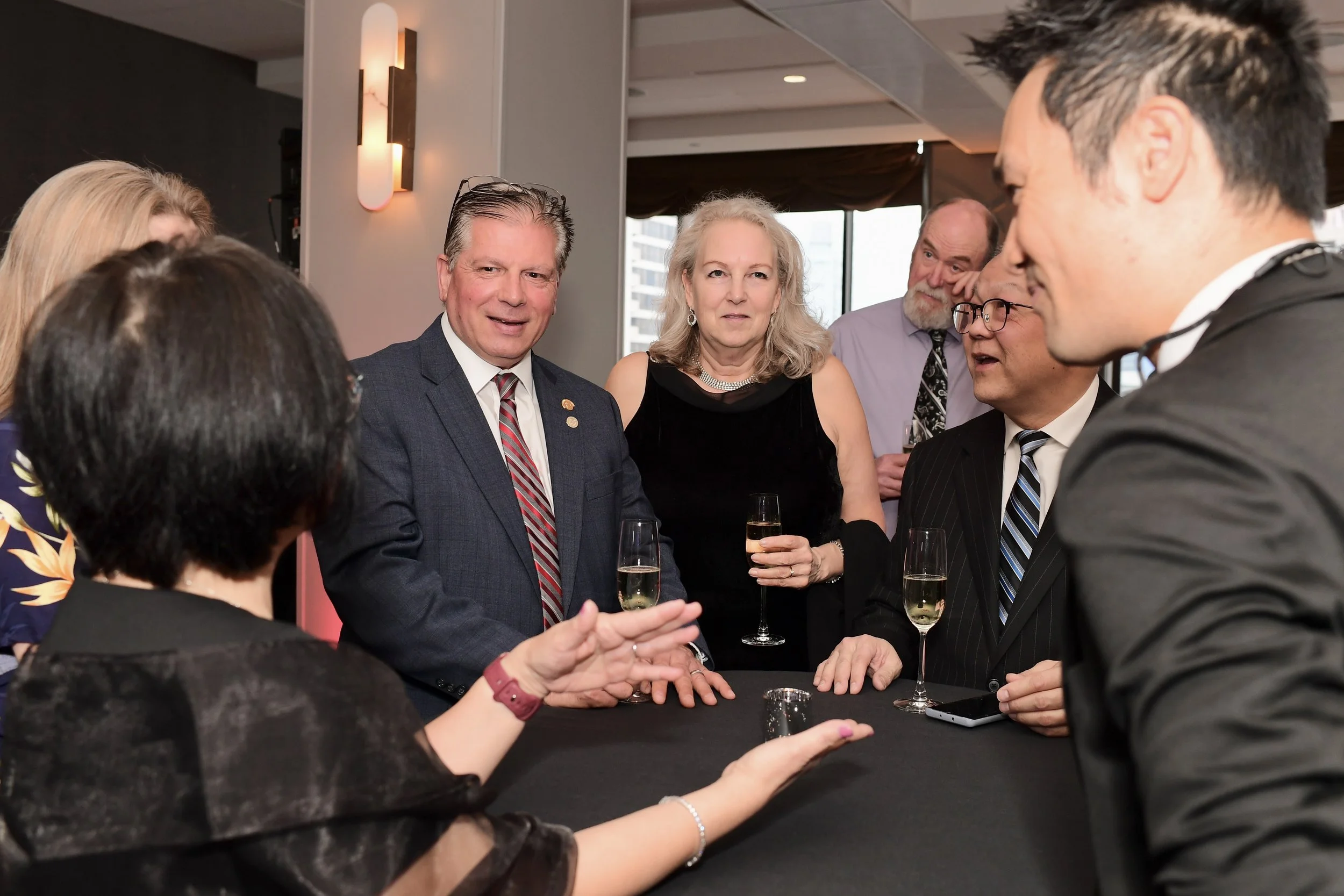 Corporate magician Kel Ng performing close-up magic for guests during cocktail hour at Sun Life Excellence Cup Fairmont Hotel Vancouver
