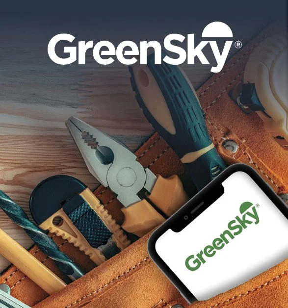 A collection of tools in a leather tool belt, including pliers, a screwdriver, a measuring tape, and a scraper, with a smartphone displaying the GreenSky logo.
