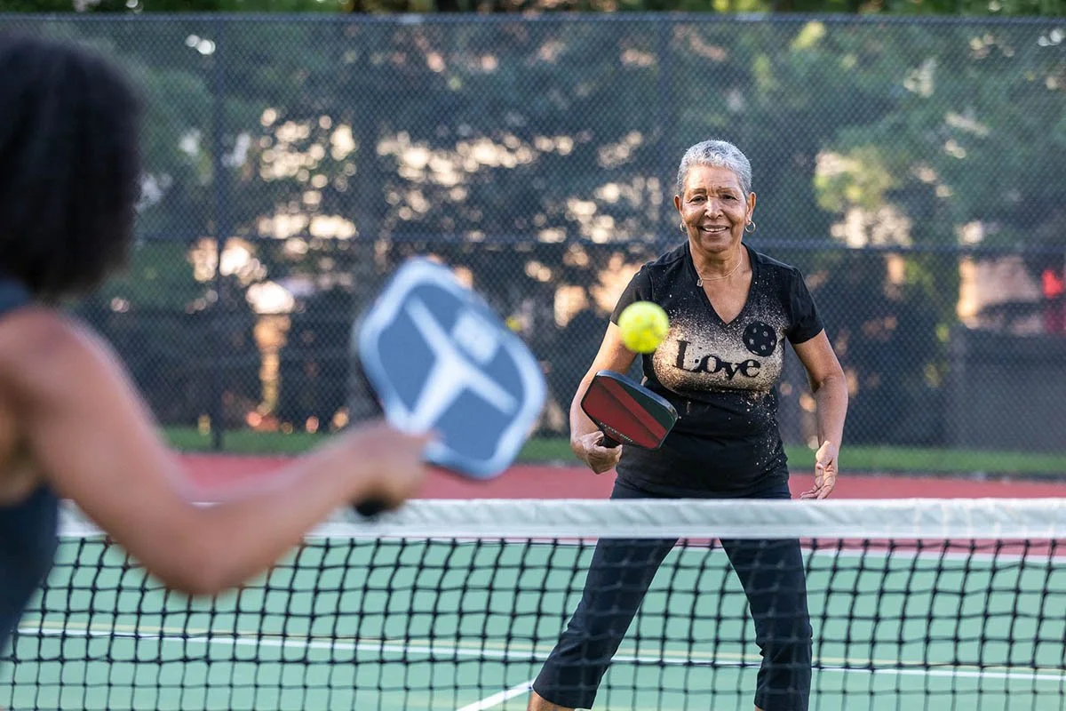 Yvette Bowman participates in pickleball, walking and tai chi chih as part of a movement story.
