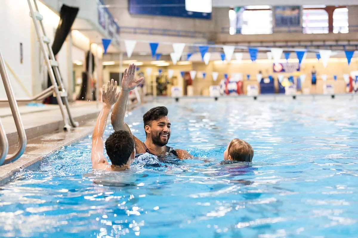 male-swim-instructor-teaching-kids-in-pool.jpg