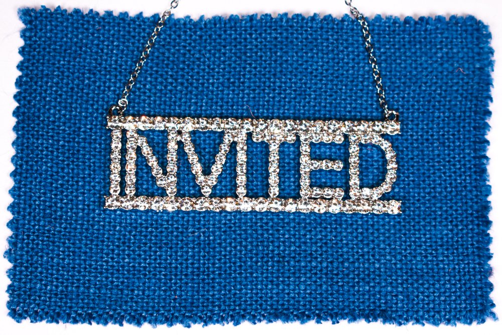 Invited-diamante-word-on-blue-linen.jpg