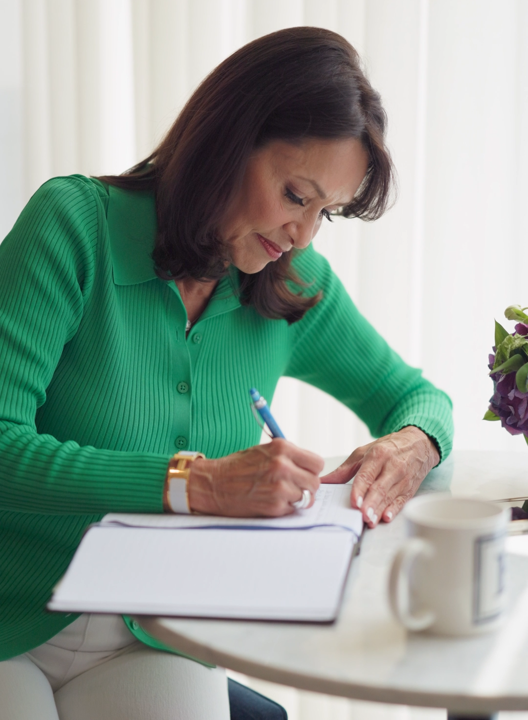Liz Brunner writing in a notebook