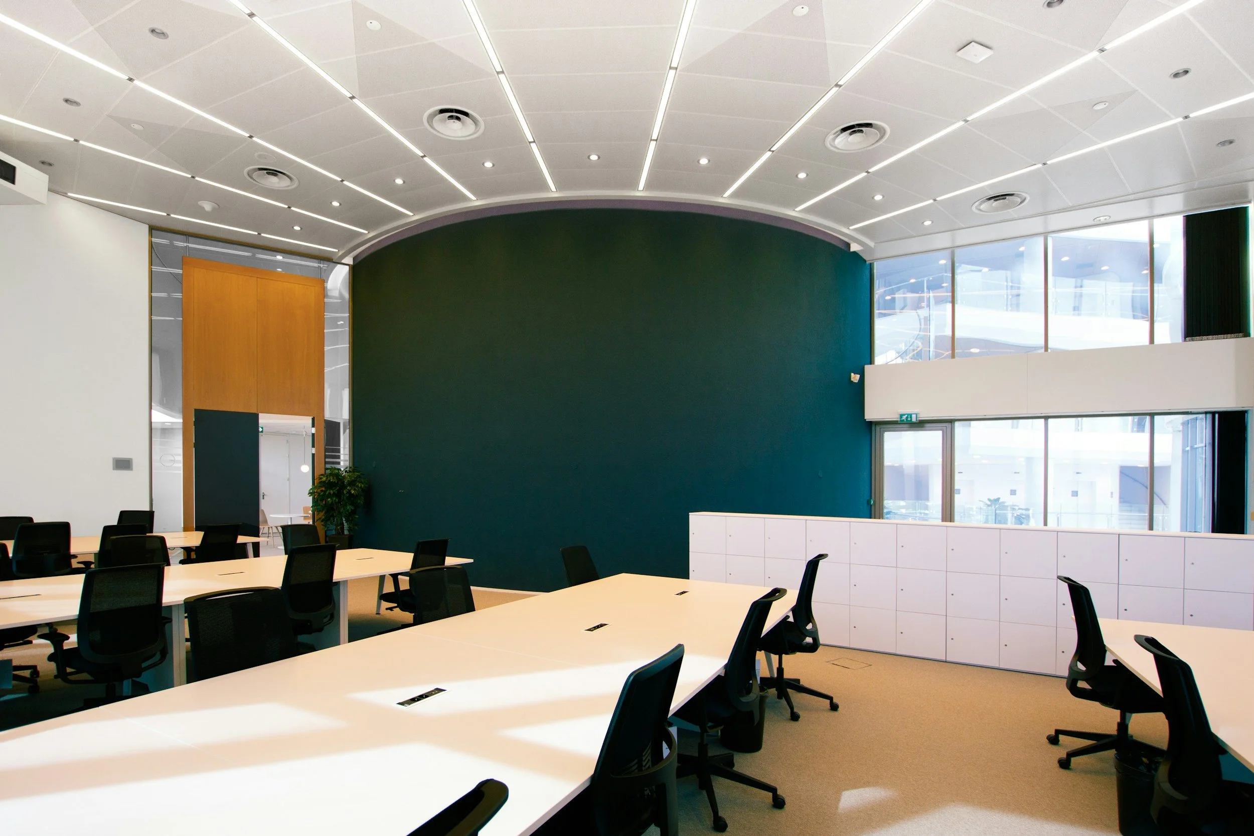 Modern architectural office space with clean lines, representing a professionally facilitated, boundary-aware sound session for institutional settings.