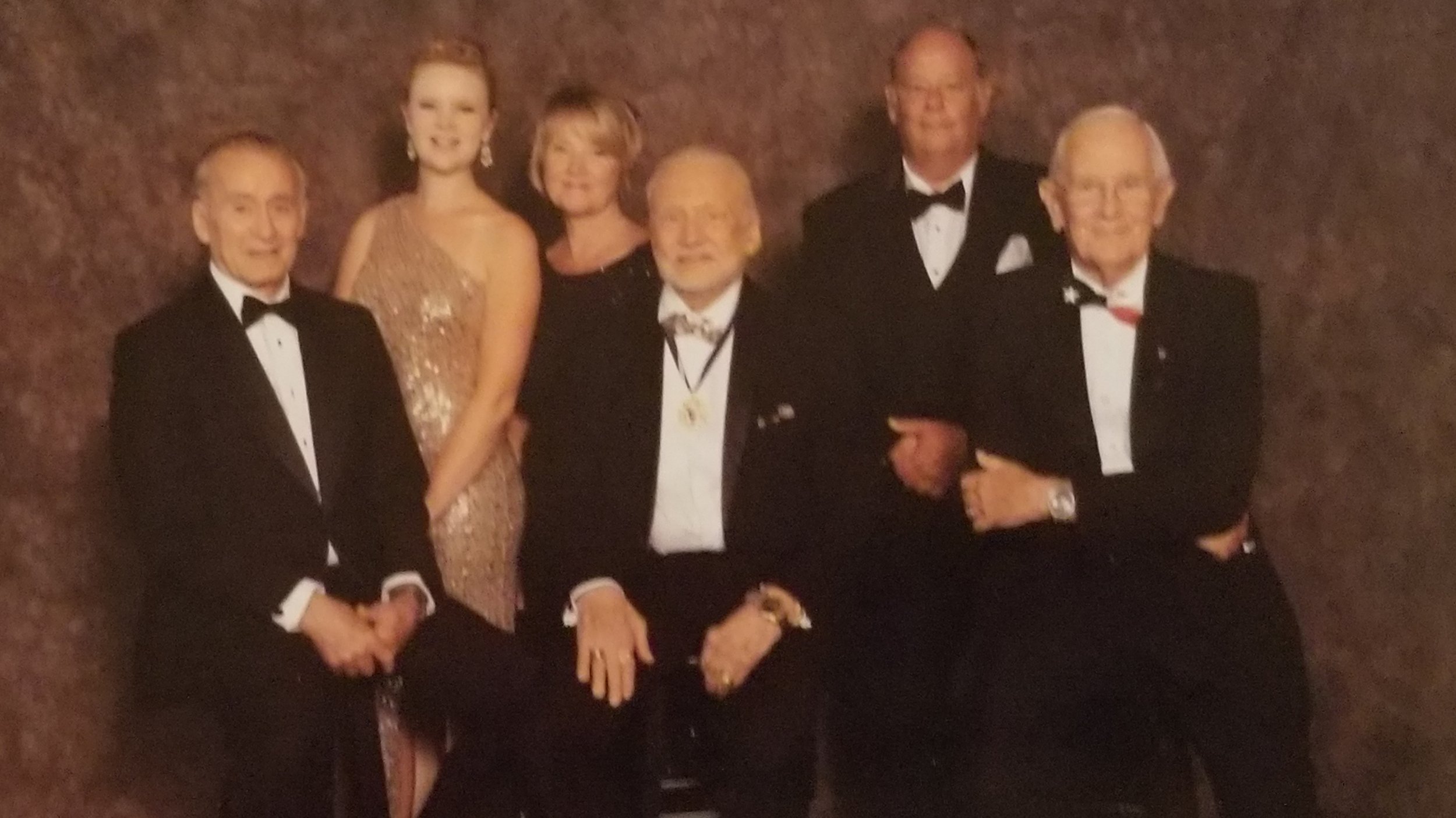 The author, her parents, Buzz Aldrin, and Walt Cunningham together at a gala, all in black tie.