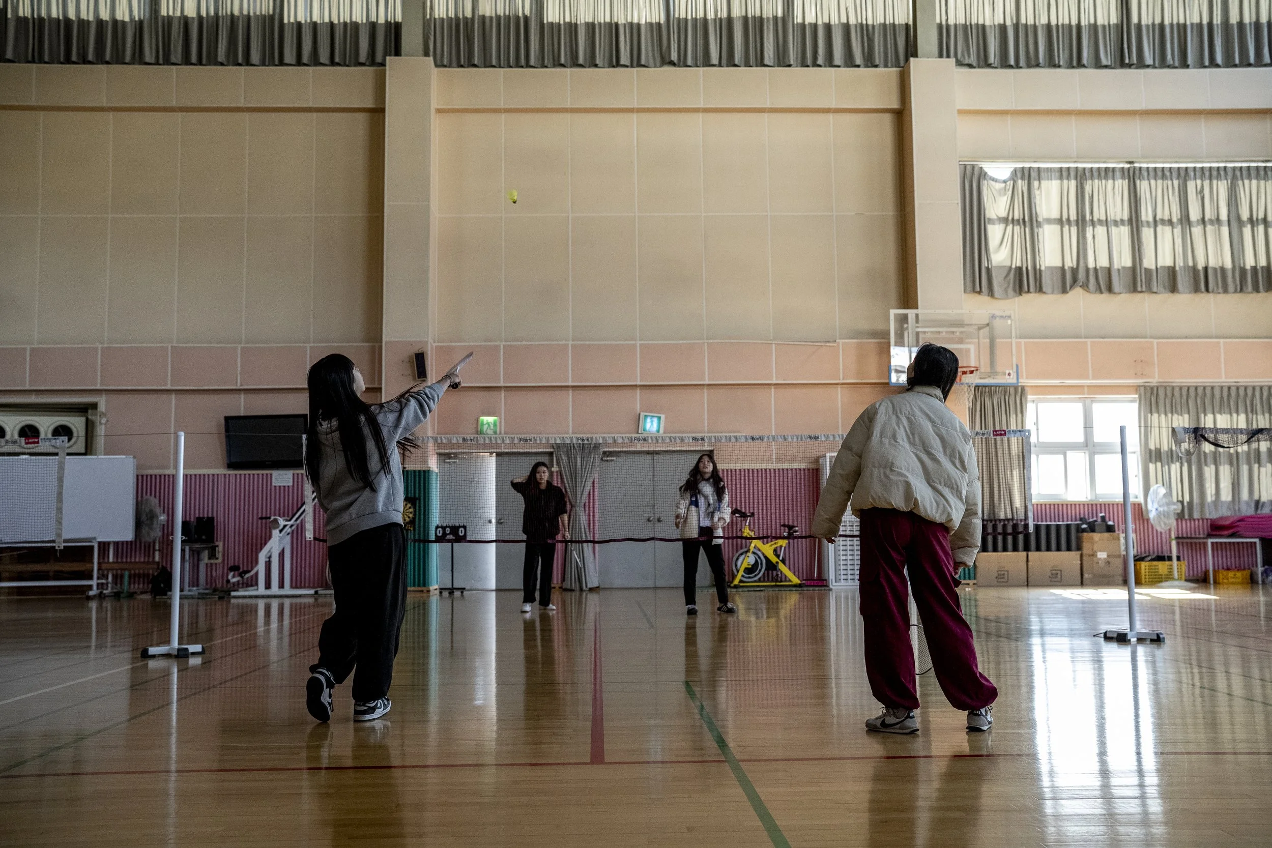 A few students enjoy a game of badminton in the gym after lunch.