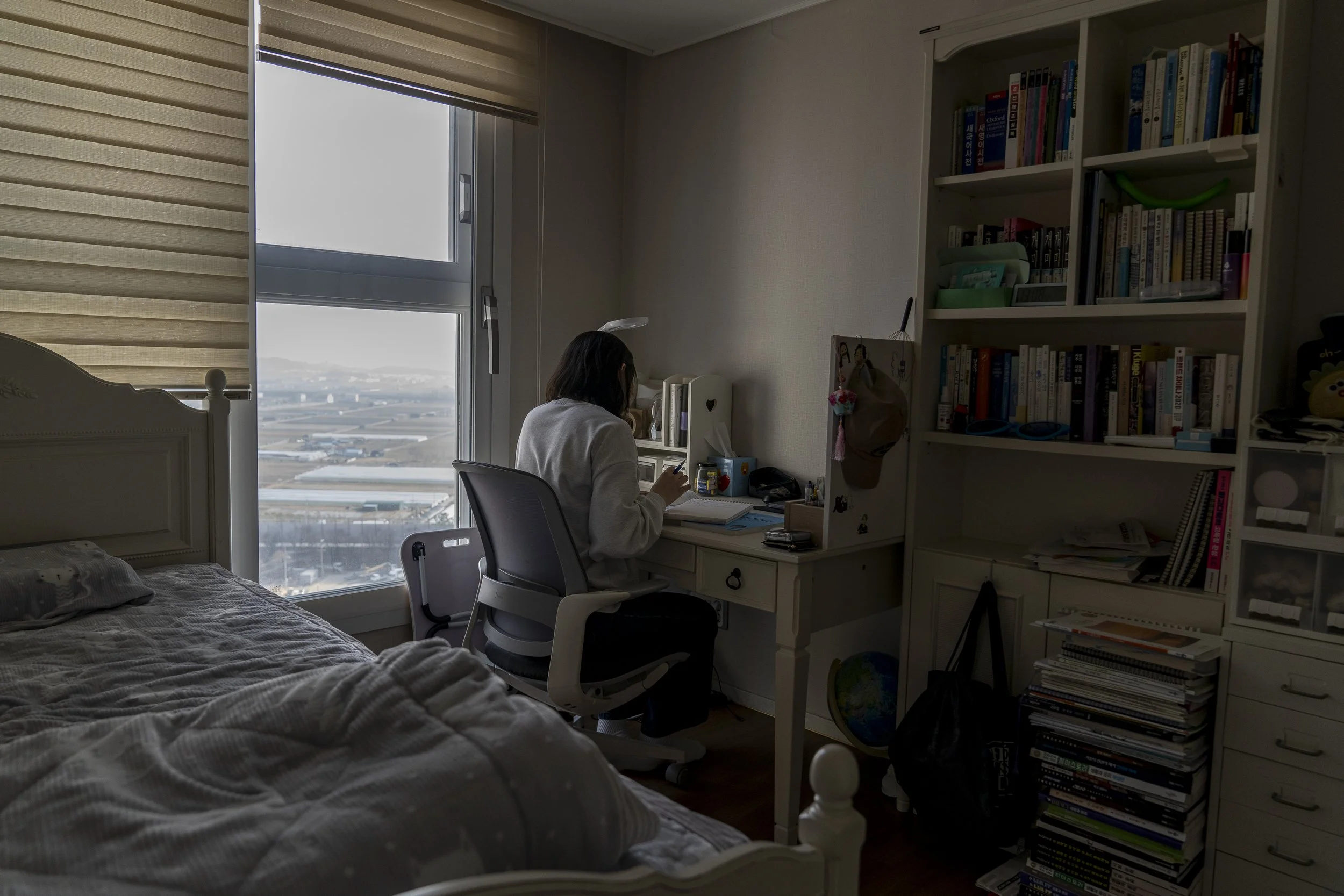 Seo Yeon* studies in her room at her home in Gimhae.