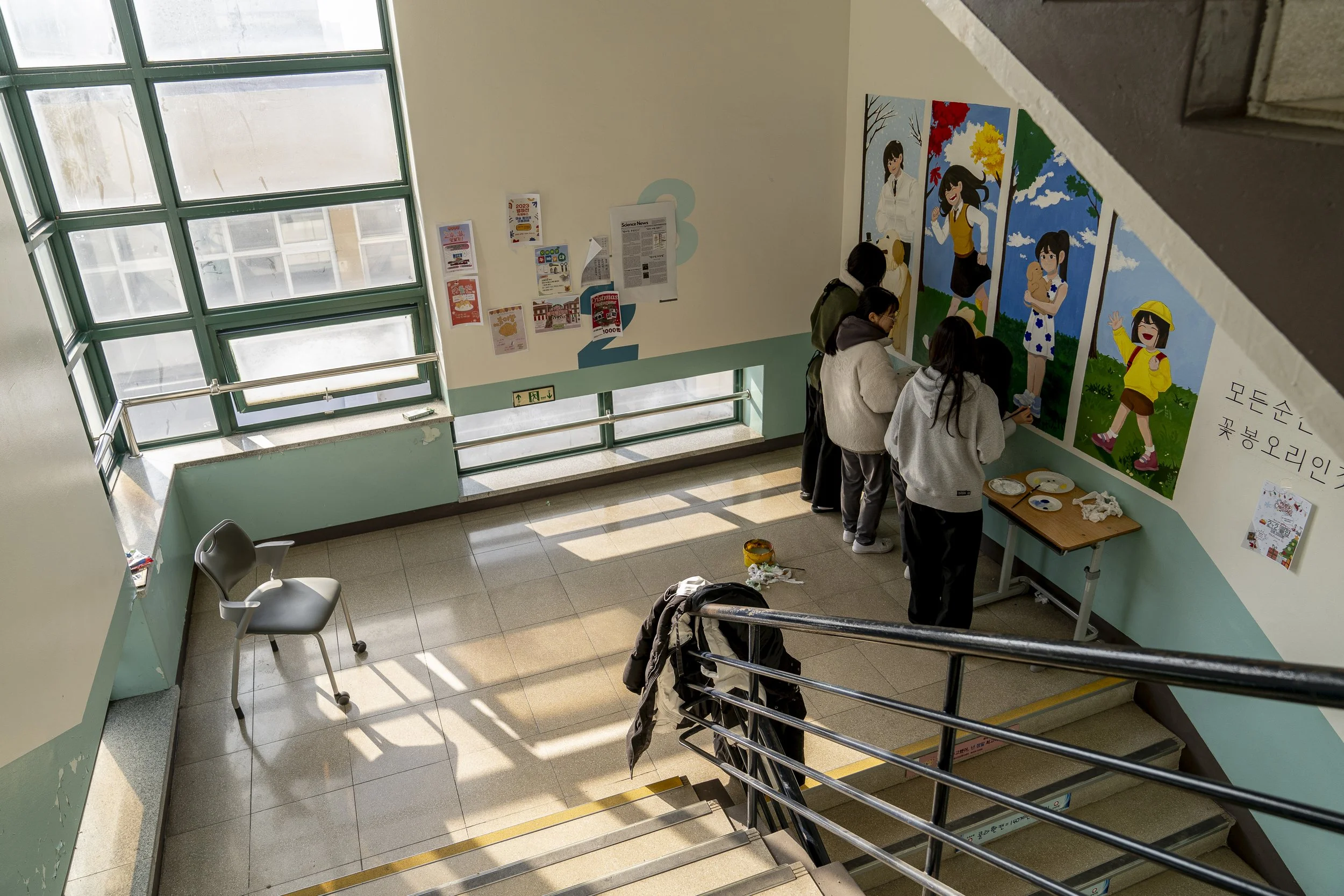 Students paint the walls at Gimhae Girls’ High School.