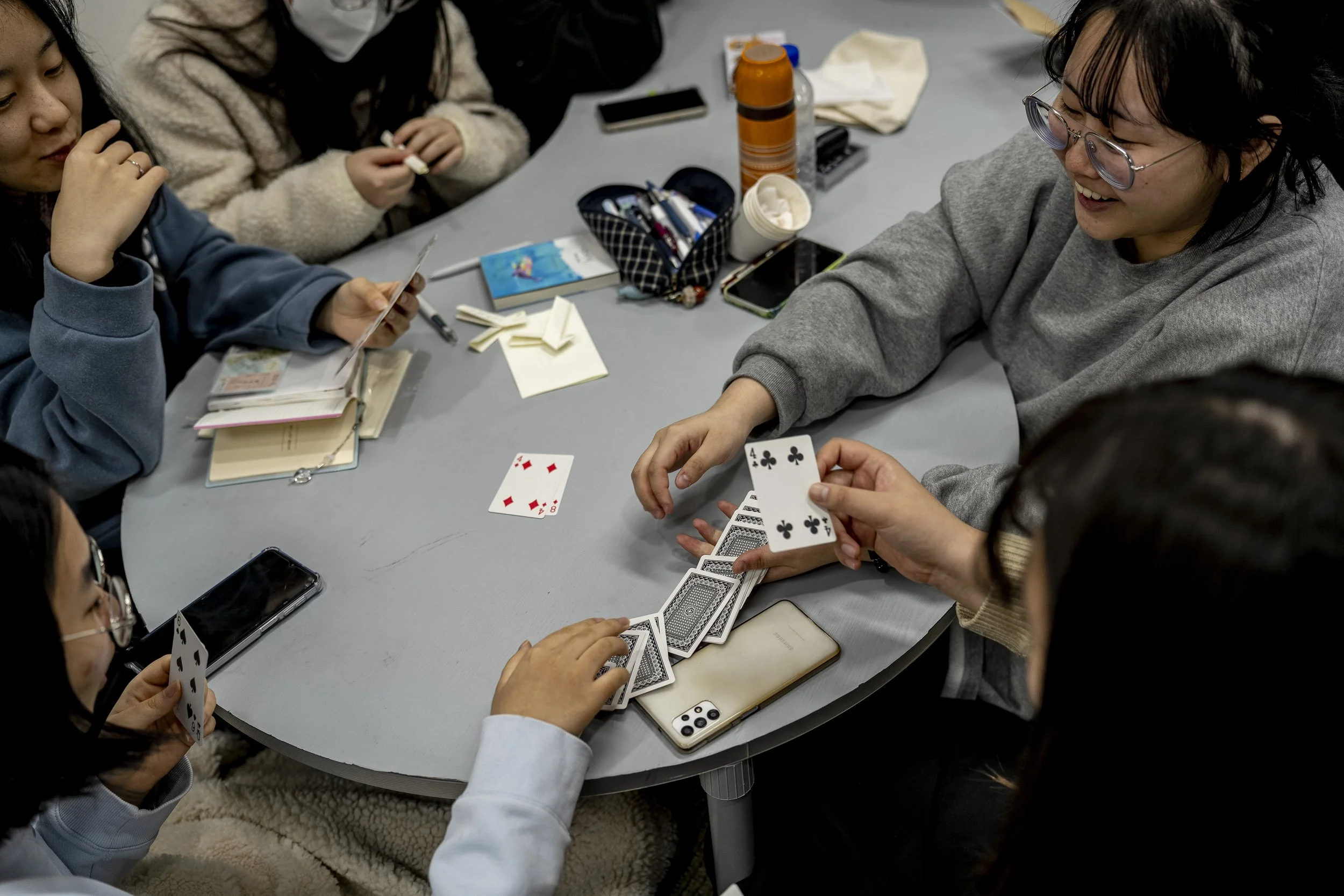 Final year students play cards games during a relaxed day in the library, two days before their graduation at Gimhae Girls’ High School.