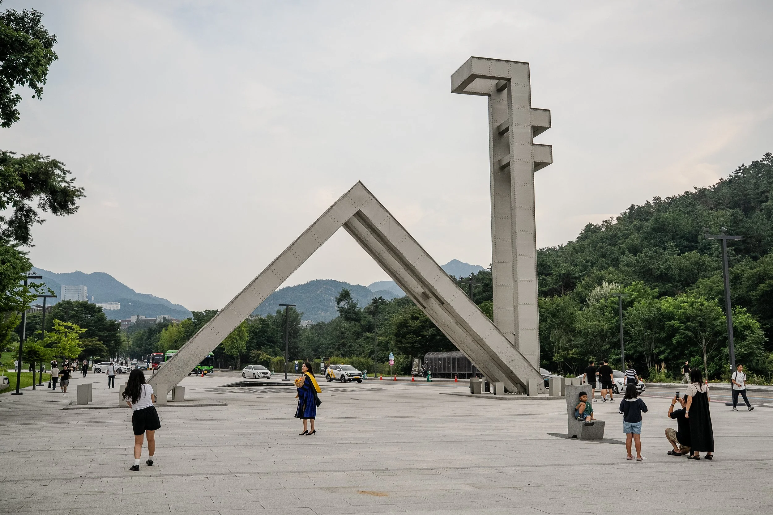 People take photos in front of the “Sha” symbol at the entrance of Seoul National University.