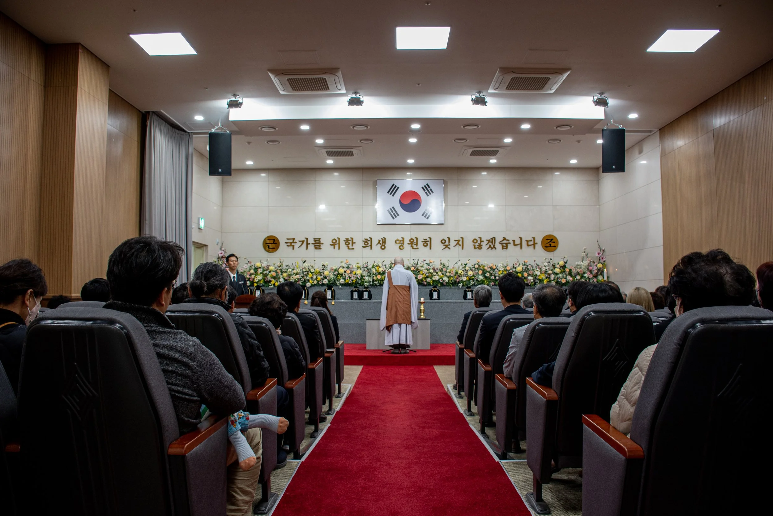 A Buddhist monk prays during the reinterring ceremony at Daejeon National Cemetery.
