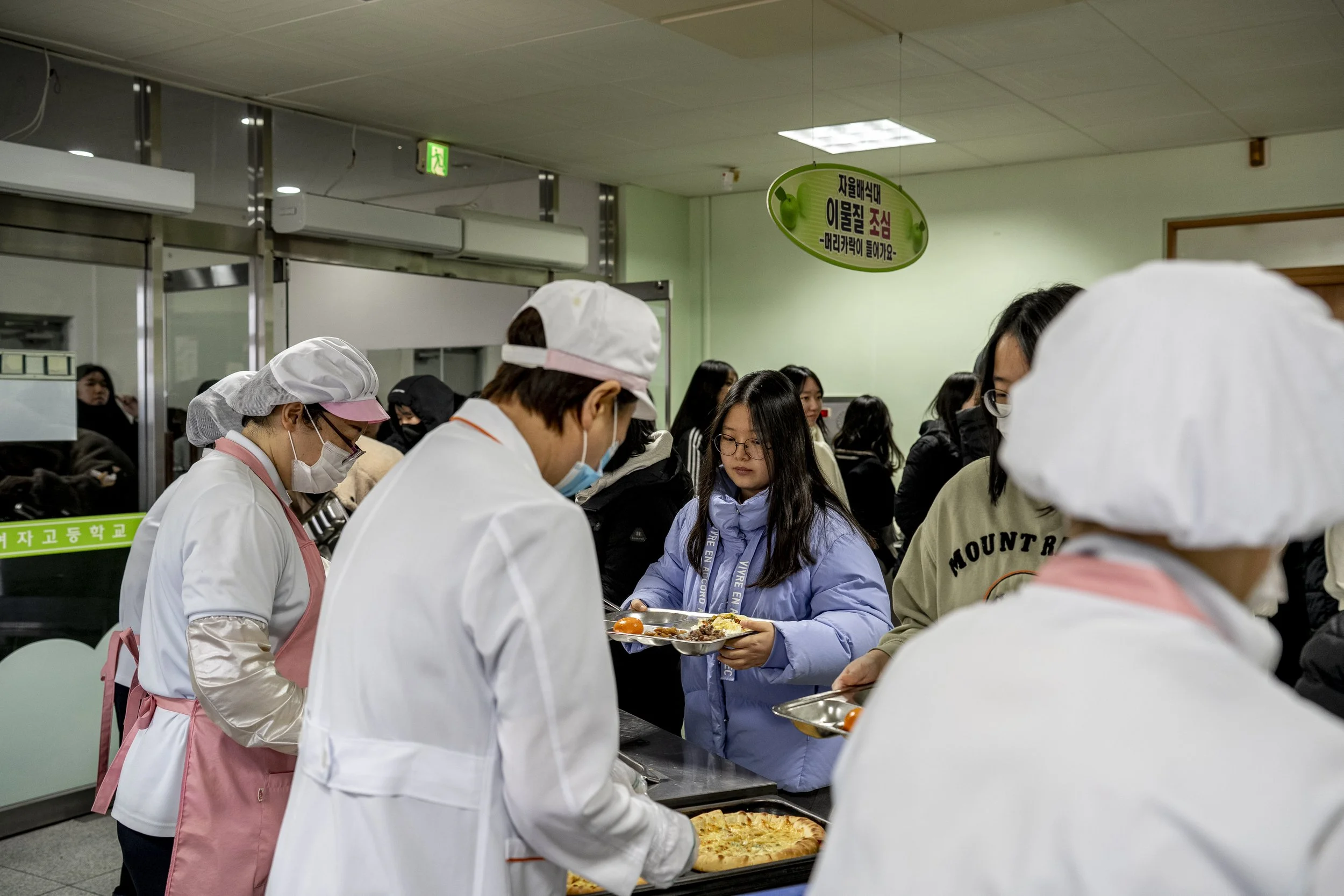 Students line up for lunch at the cafeteria.