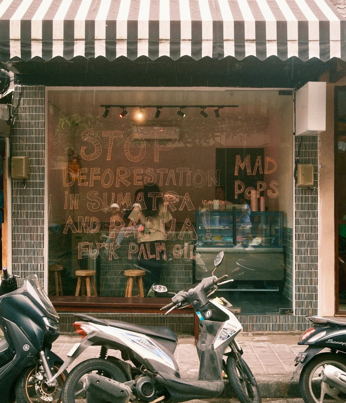 Seminyak is open. Not finished just open. The rest will come slowly, between melts and holidays.

For now, the windows stay handwritten. Thoughts, feelings, reminders. Because outside these walls, forests are disappearing, floods are happening, and t