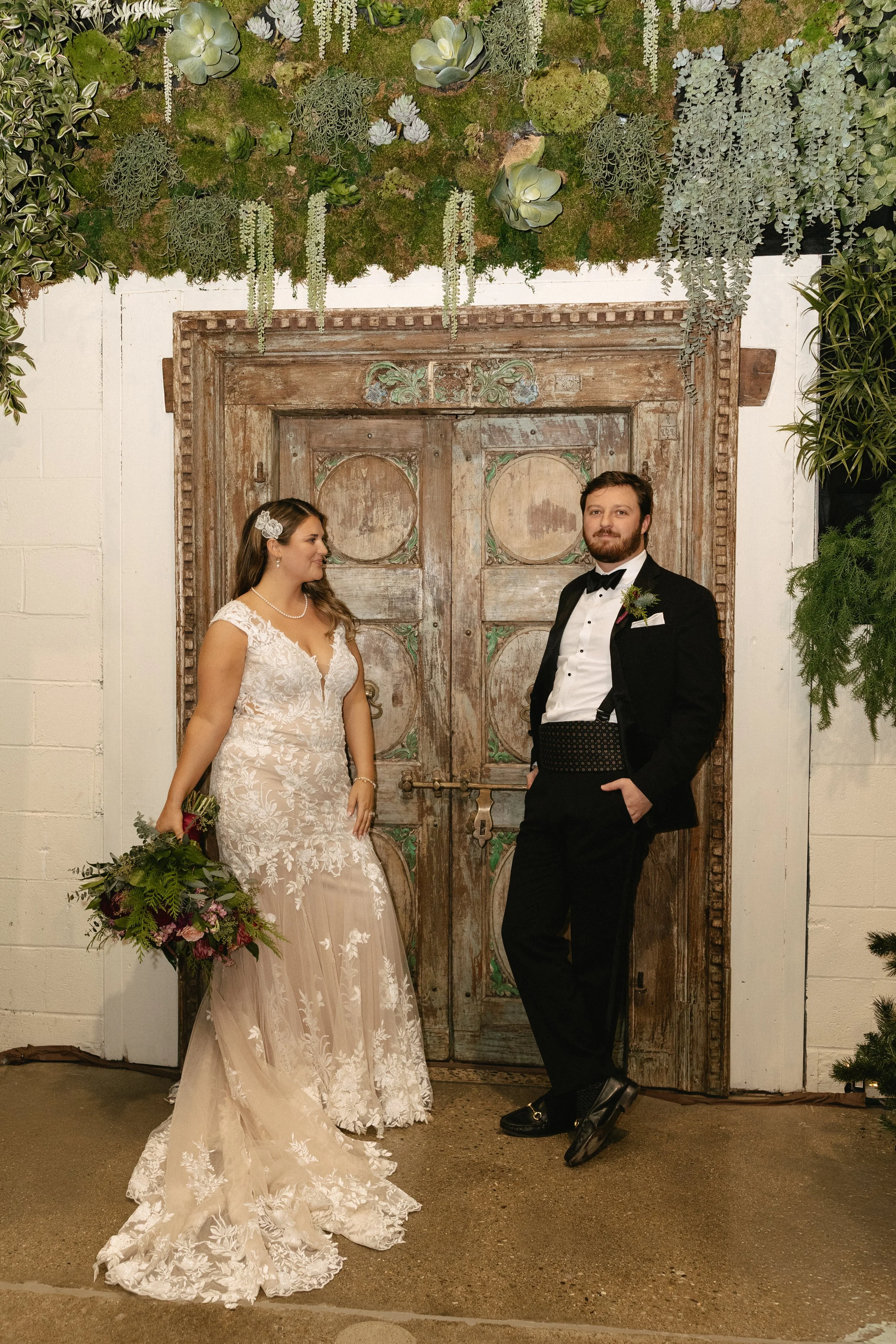 Bride looking at her groom against the historic doors at Germantown Gables in Louisville, Kentucky.