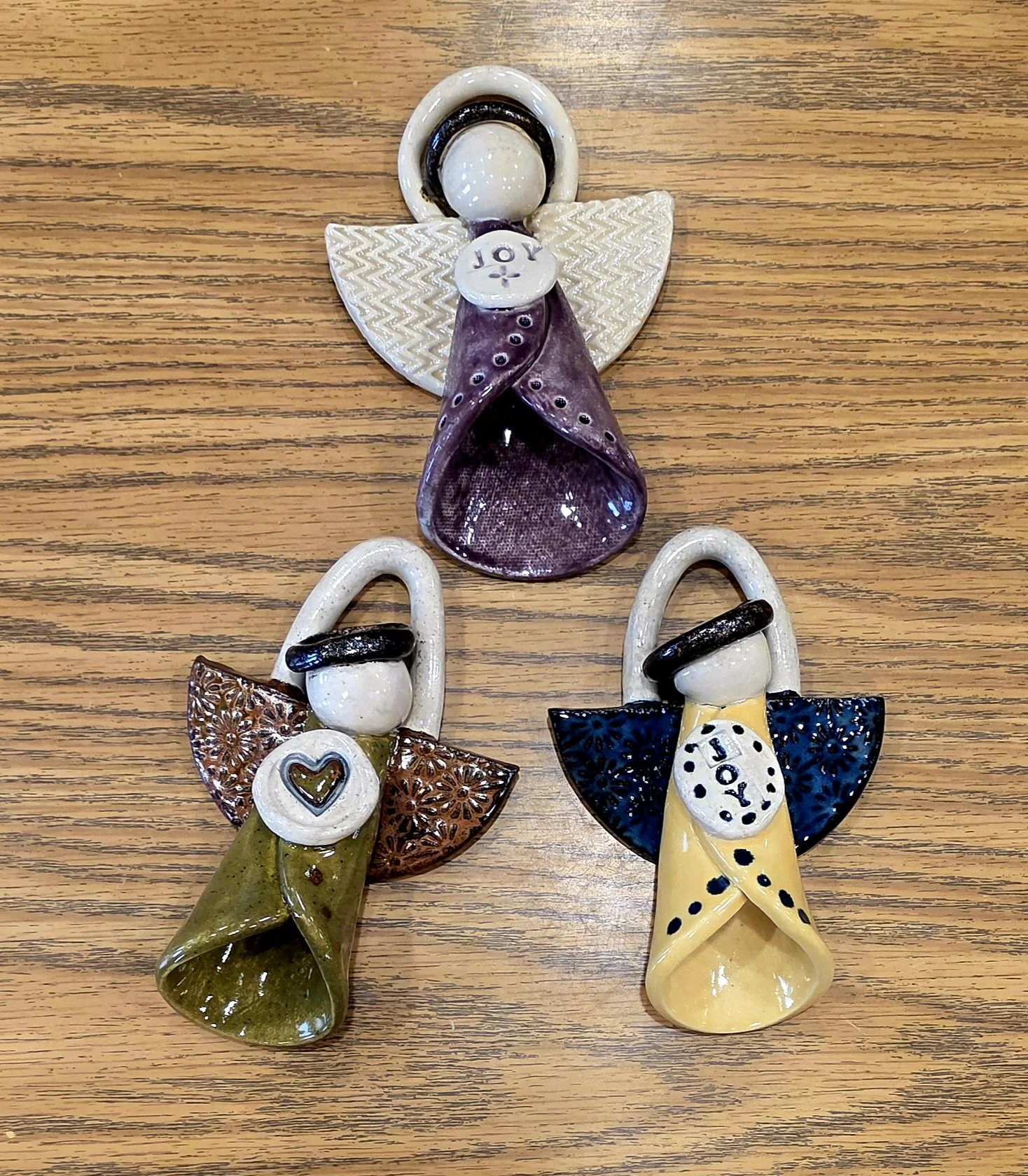 Various ceramic angels in multiple colors.